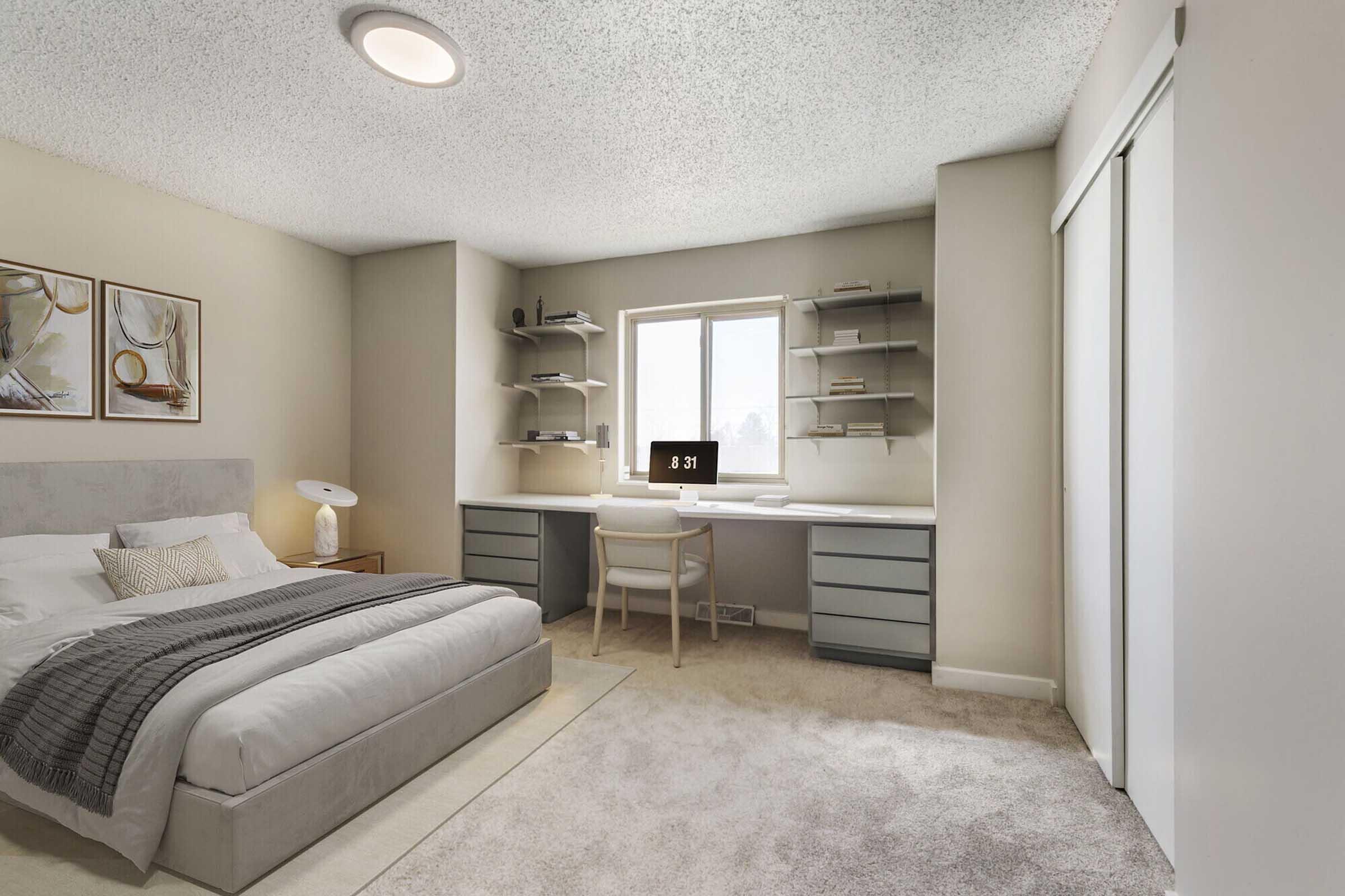 A modern bedroom featuring a queen-sized bed with a light gray upholstered headboard, soft bedding, and a decorative throw. A window lets in natural light next to a sleek desk with shelving above, a chair, and a digital clock. The room has carpeted flooring and light-colored walls, creating a cozy atmosphere.