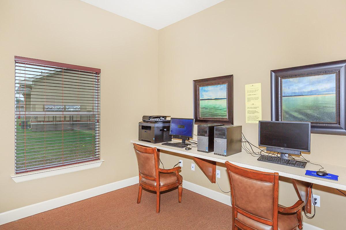 a living room with a computer on a table