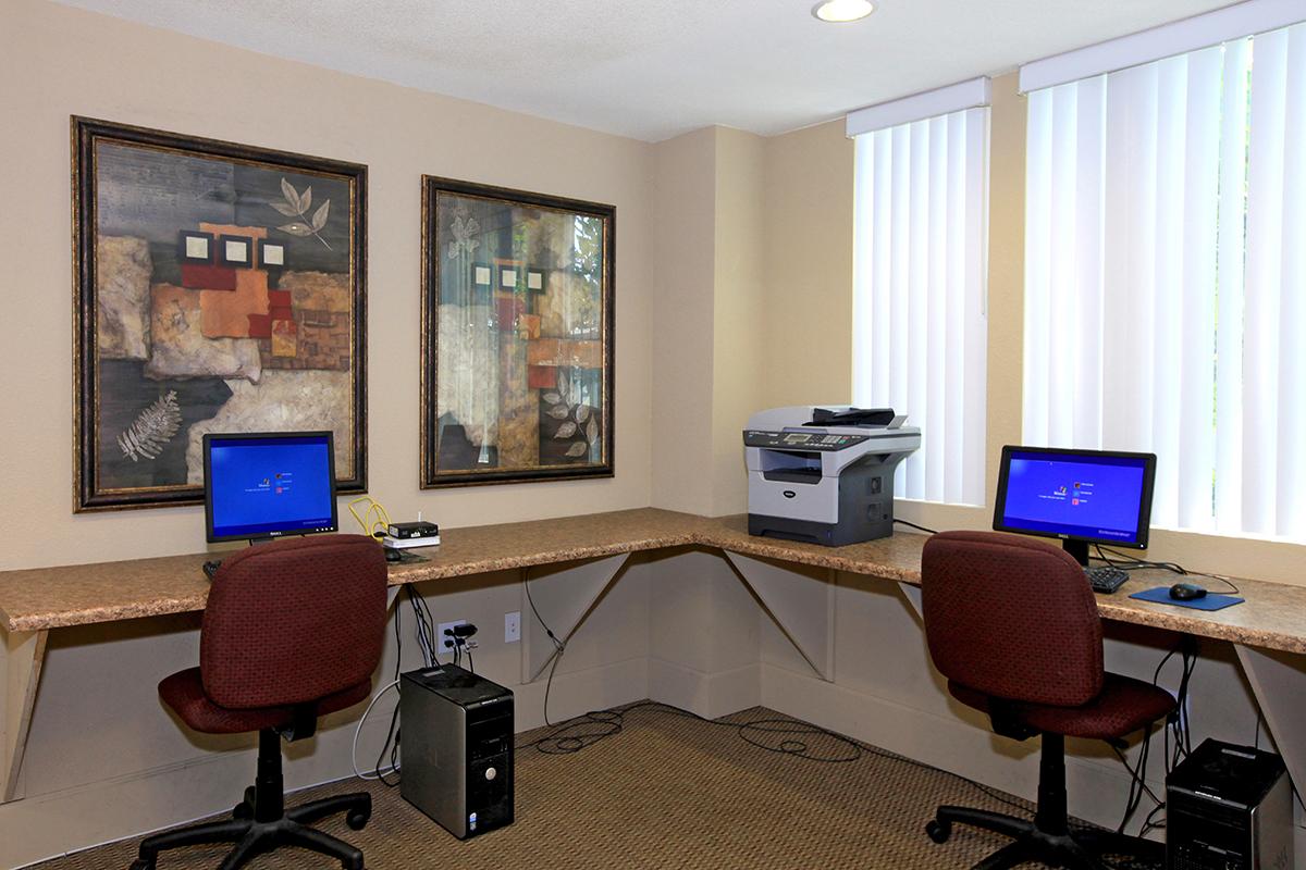 Computer room with two monitors and chairs