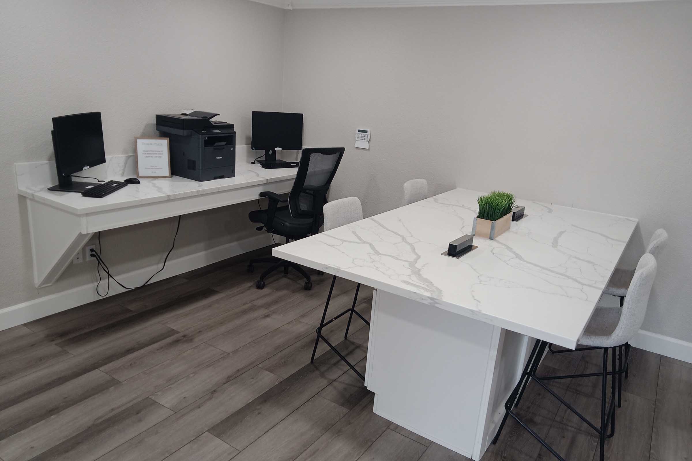 a desk with a computer on a table