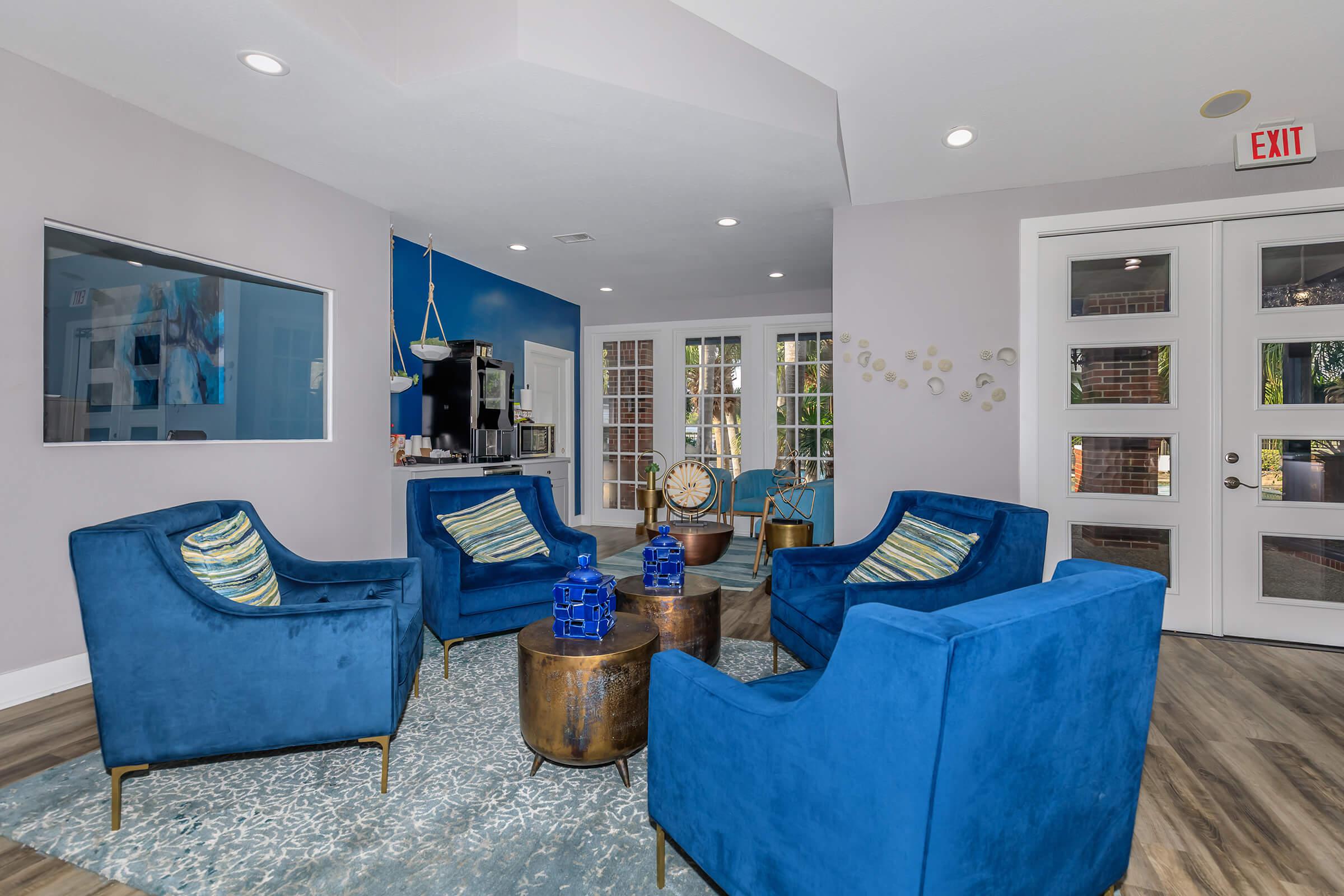 a living room filled with furniture and a large window