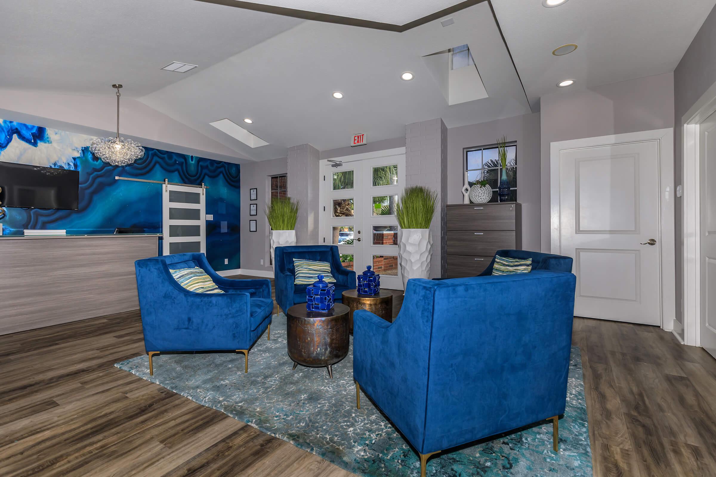 a living room filled with furniture and a blue sky