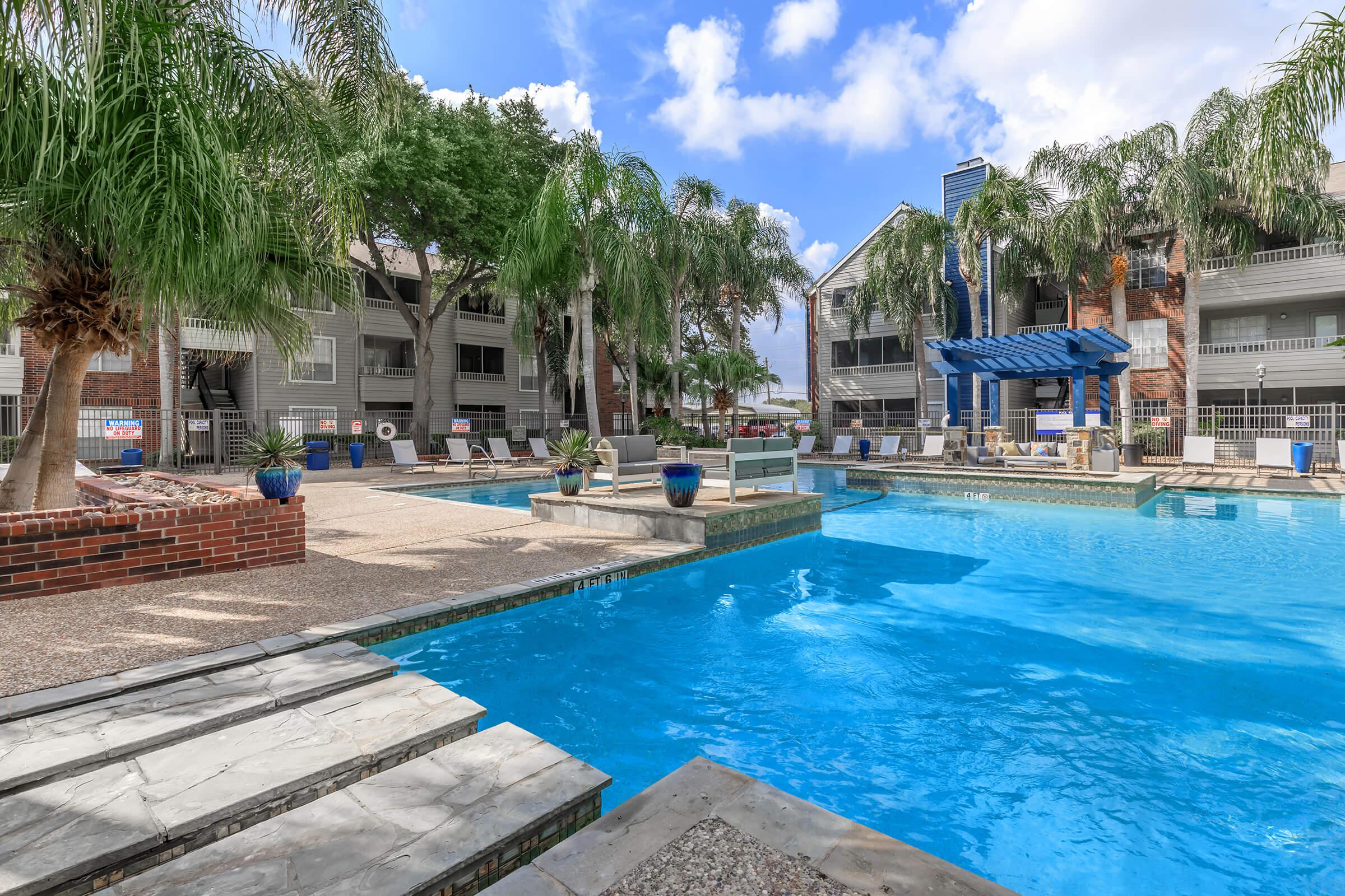 a group of lawn chairs sitting next to a pool of water