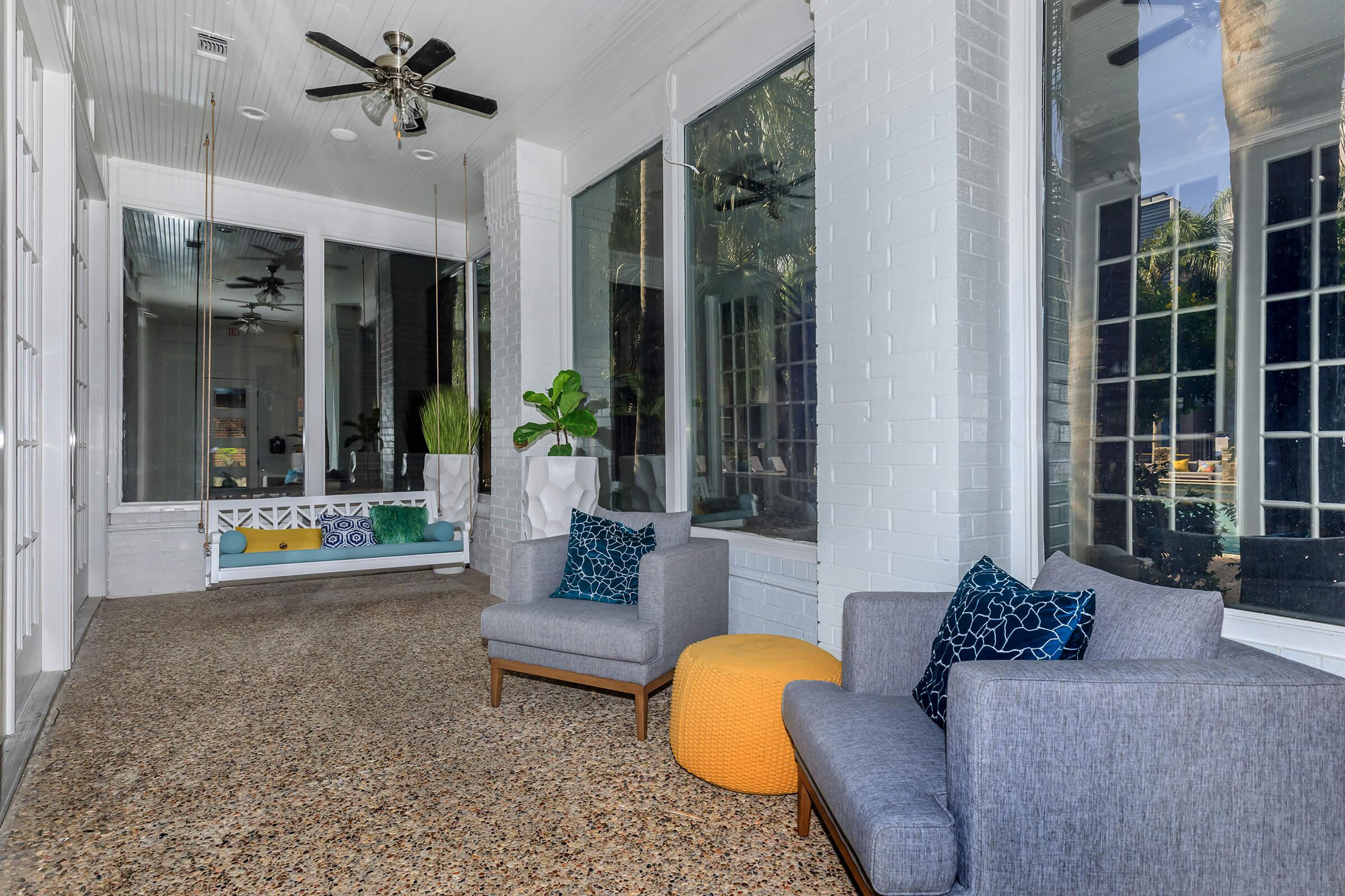 a living room filled with furniture and a large window