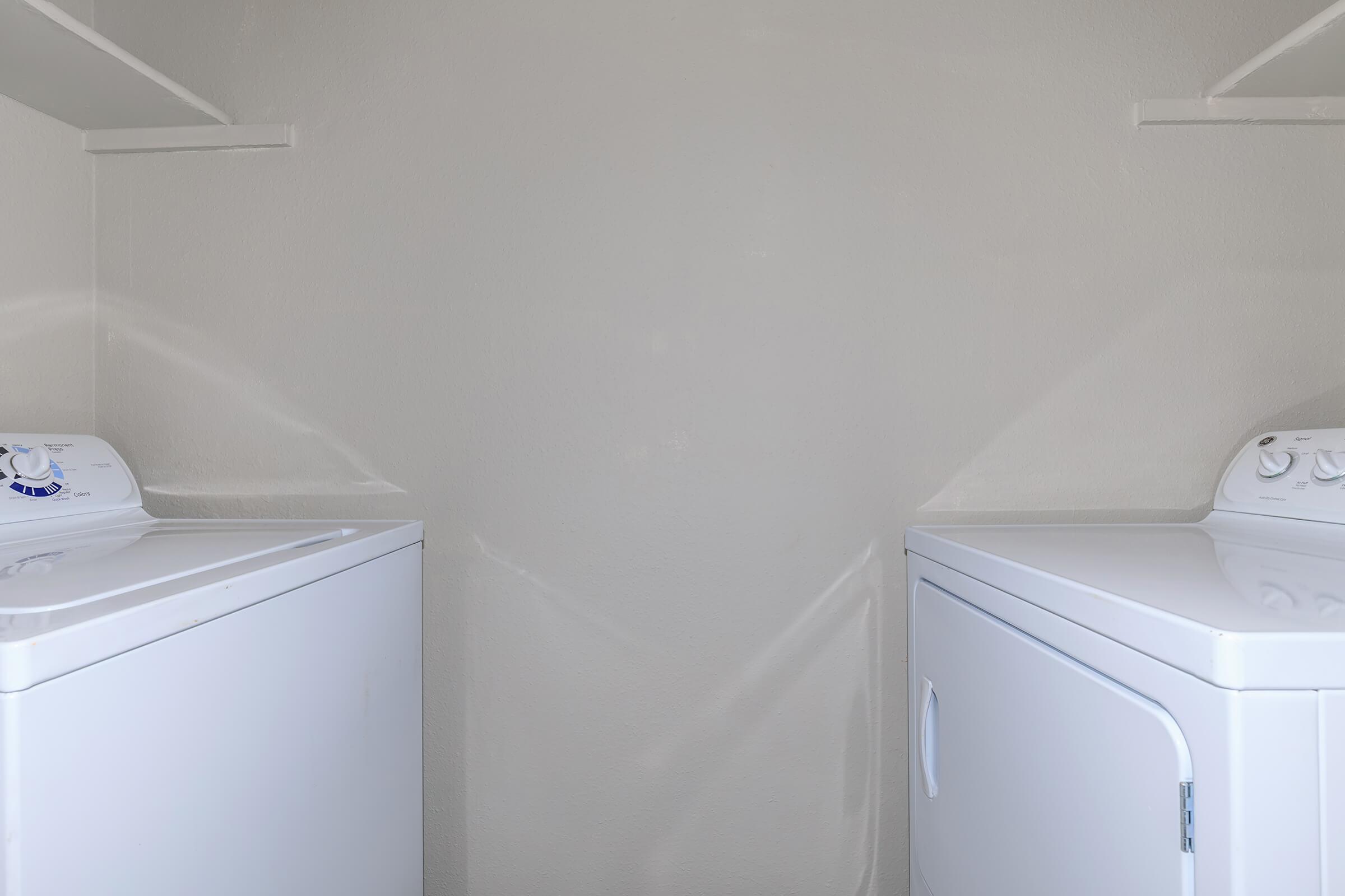 a white microwave oven sitting on top of a refrigerator