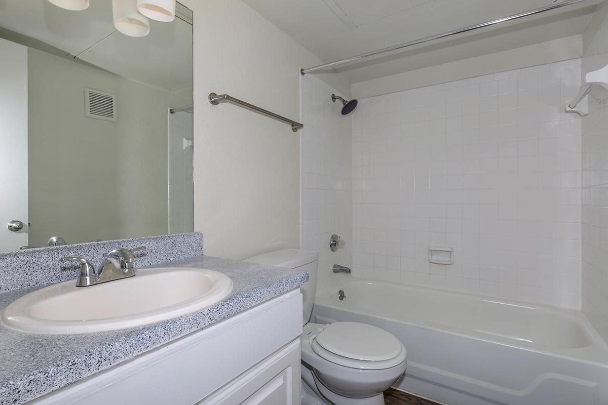 a large white tub next to a sink