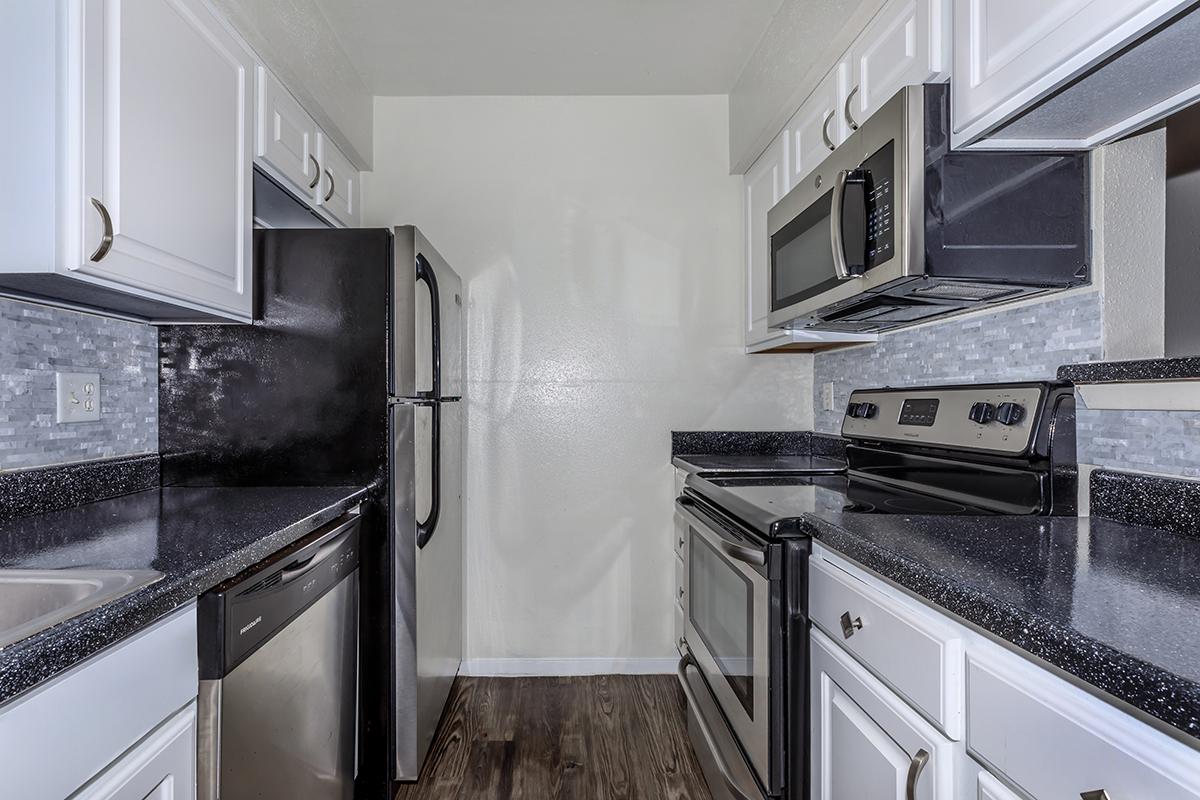 a stove top oven sitting inside of a kitchen