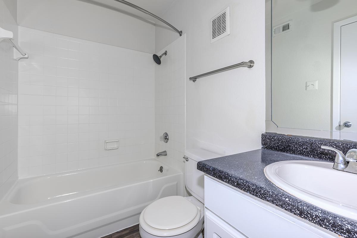 a white tub sitting next to a sink