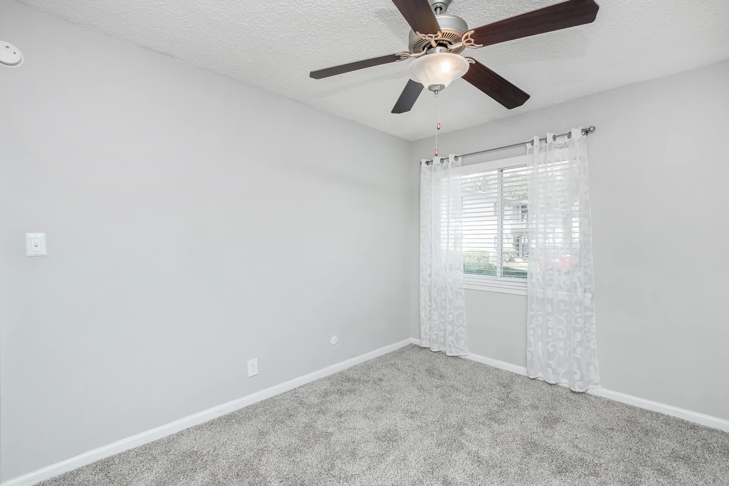 bedroom with window and ceiling fan