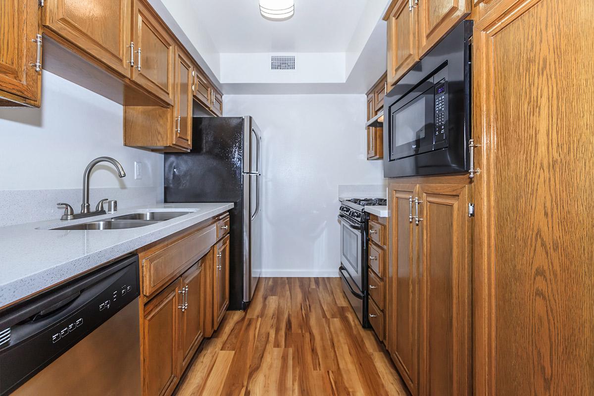 a kitchen with stainless steel appliances and wooden cabinets