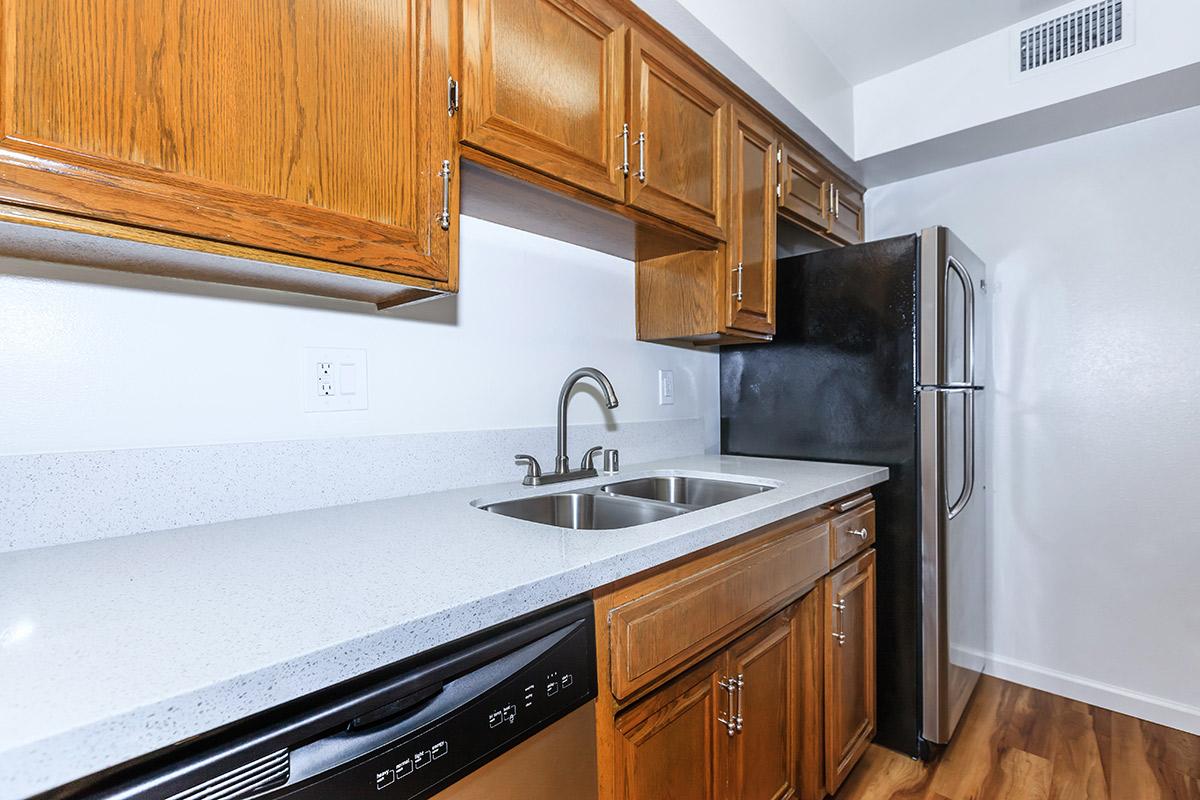 a kitchen with stainless steel appliances and wooden cabinets