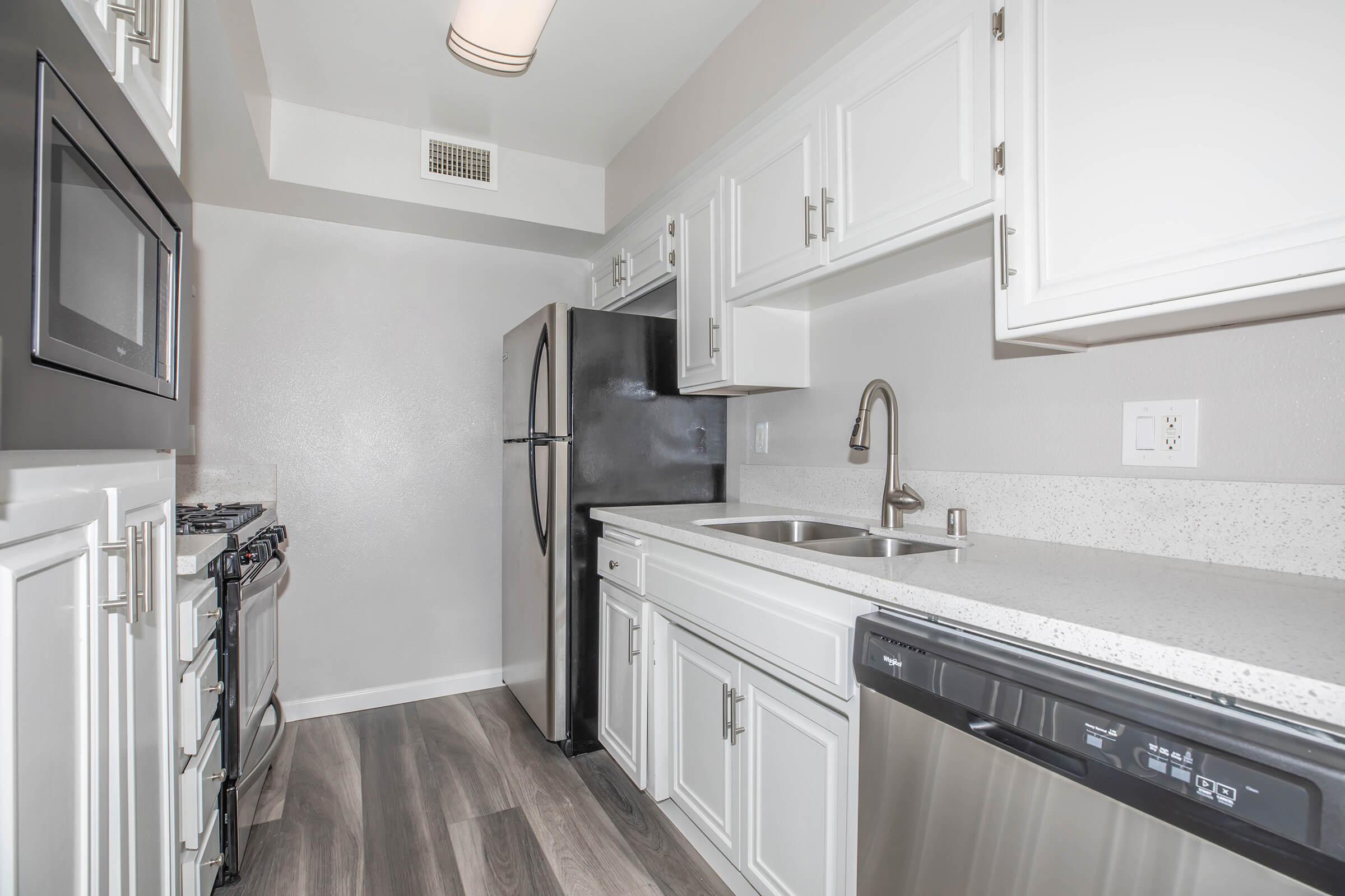 a kitchen with a sink and a mirror