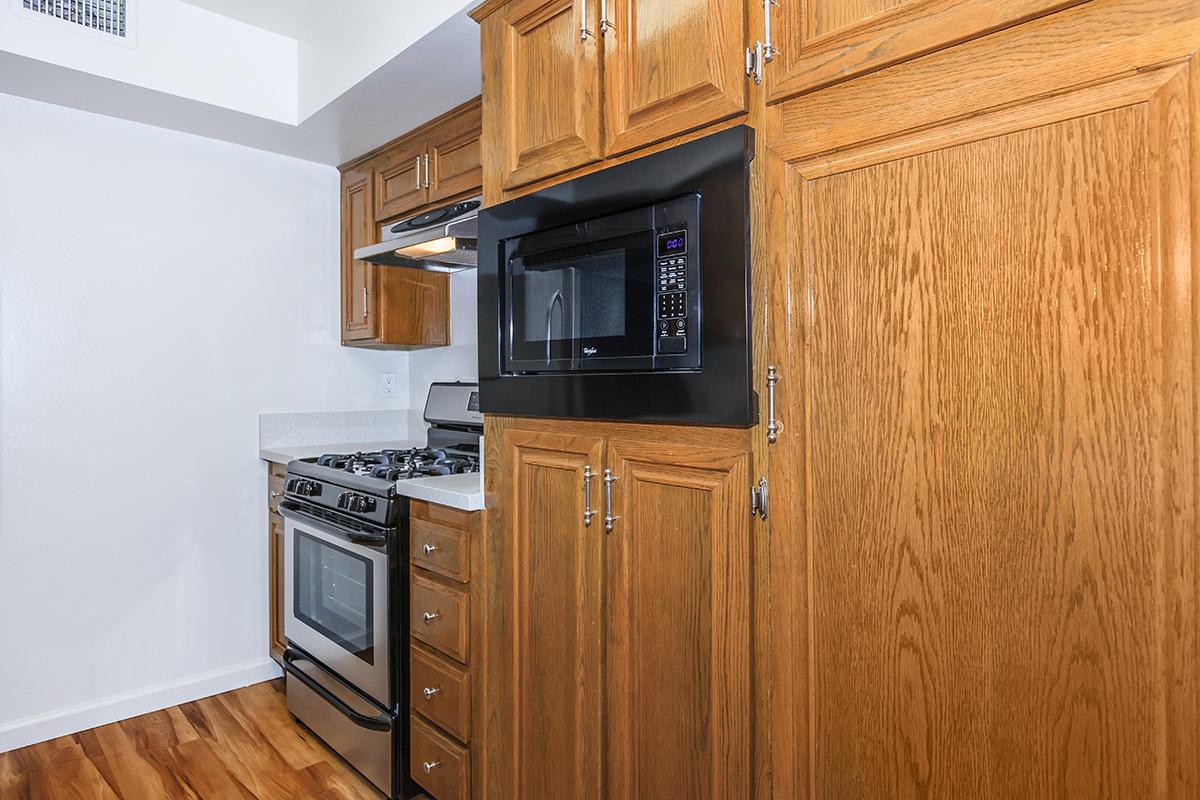 a kitchen with stainless steel appliances and wooden cabinets