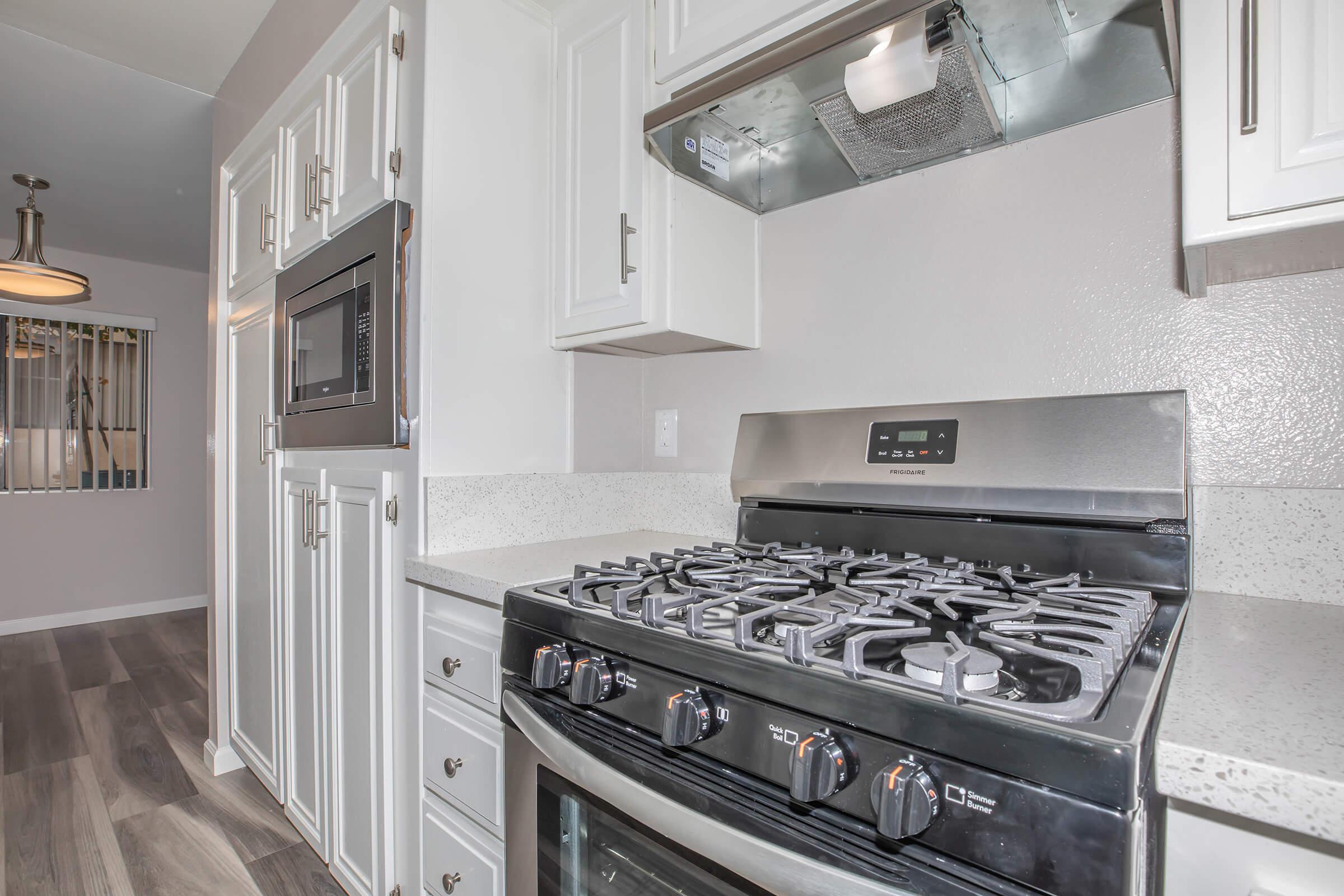 a stove top oven sitting inside of a kitchen