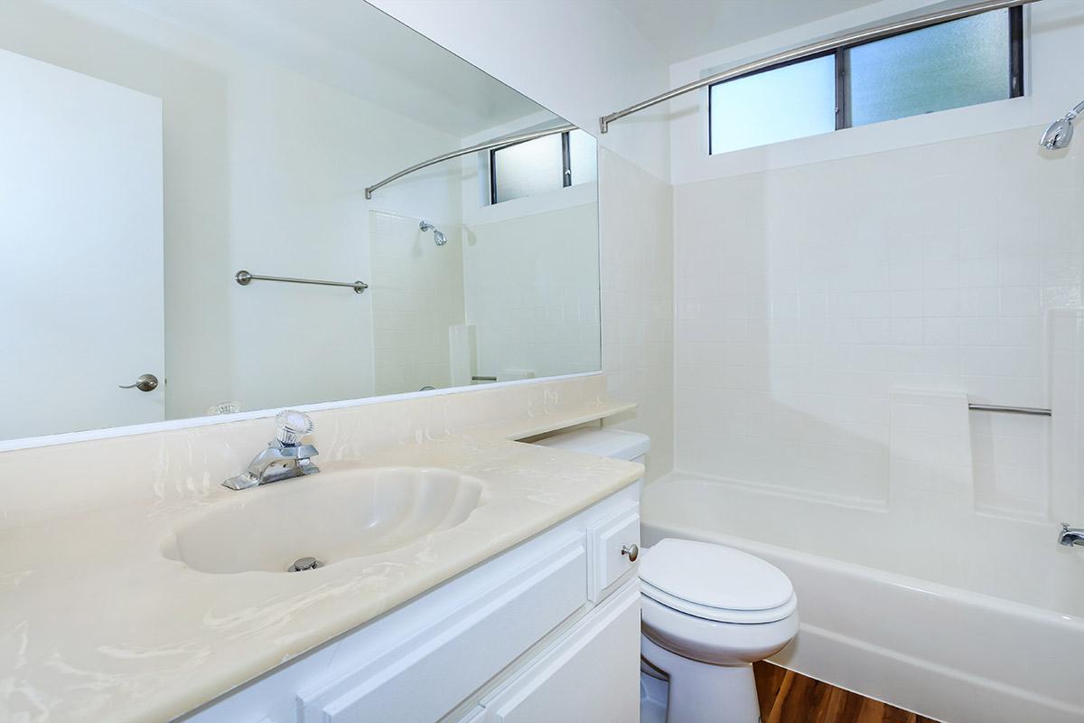 a large white tub sitting next to a sink
