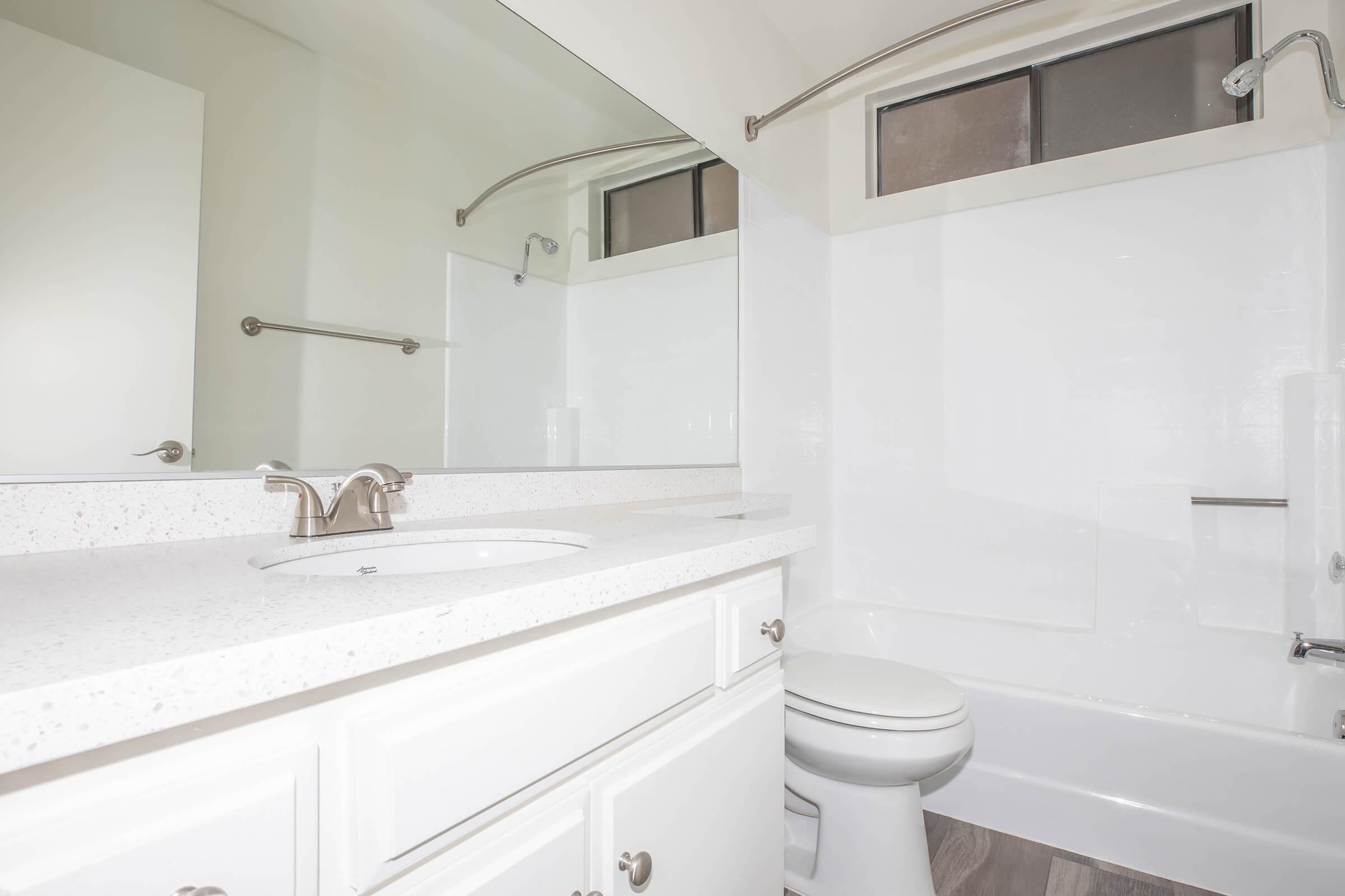 a room with a sink and a mirror