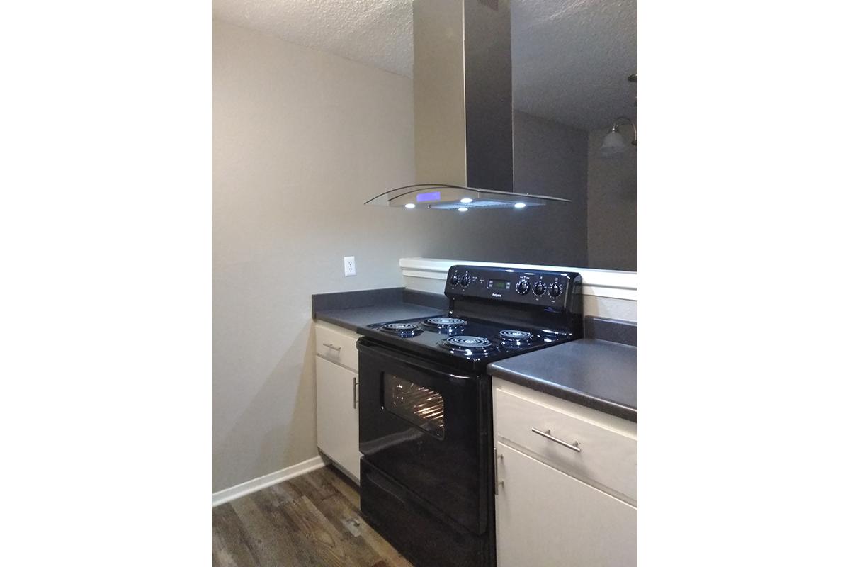 a kitchen with a stove top oven