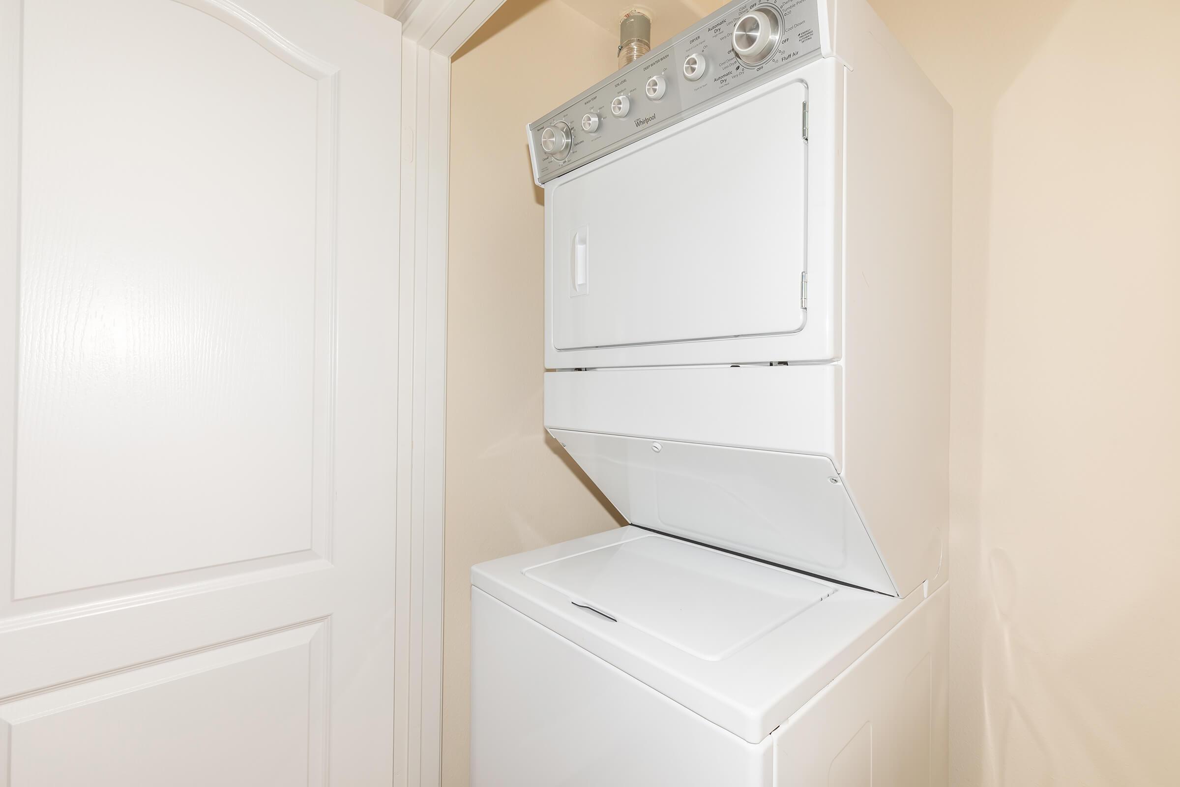 a white microwave oven sitting on top of a refrigerator