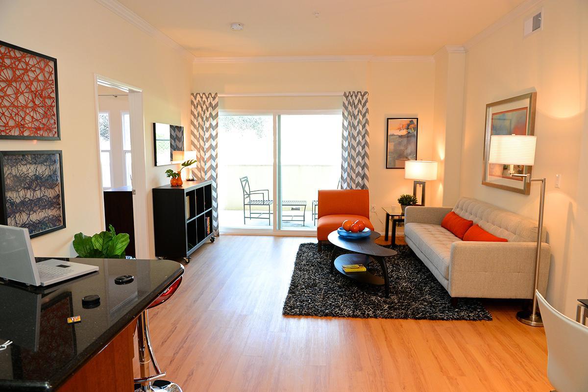 a living room filled with furniture and a flat screen tv