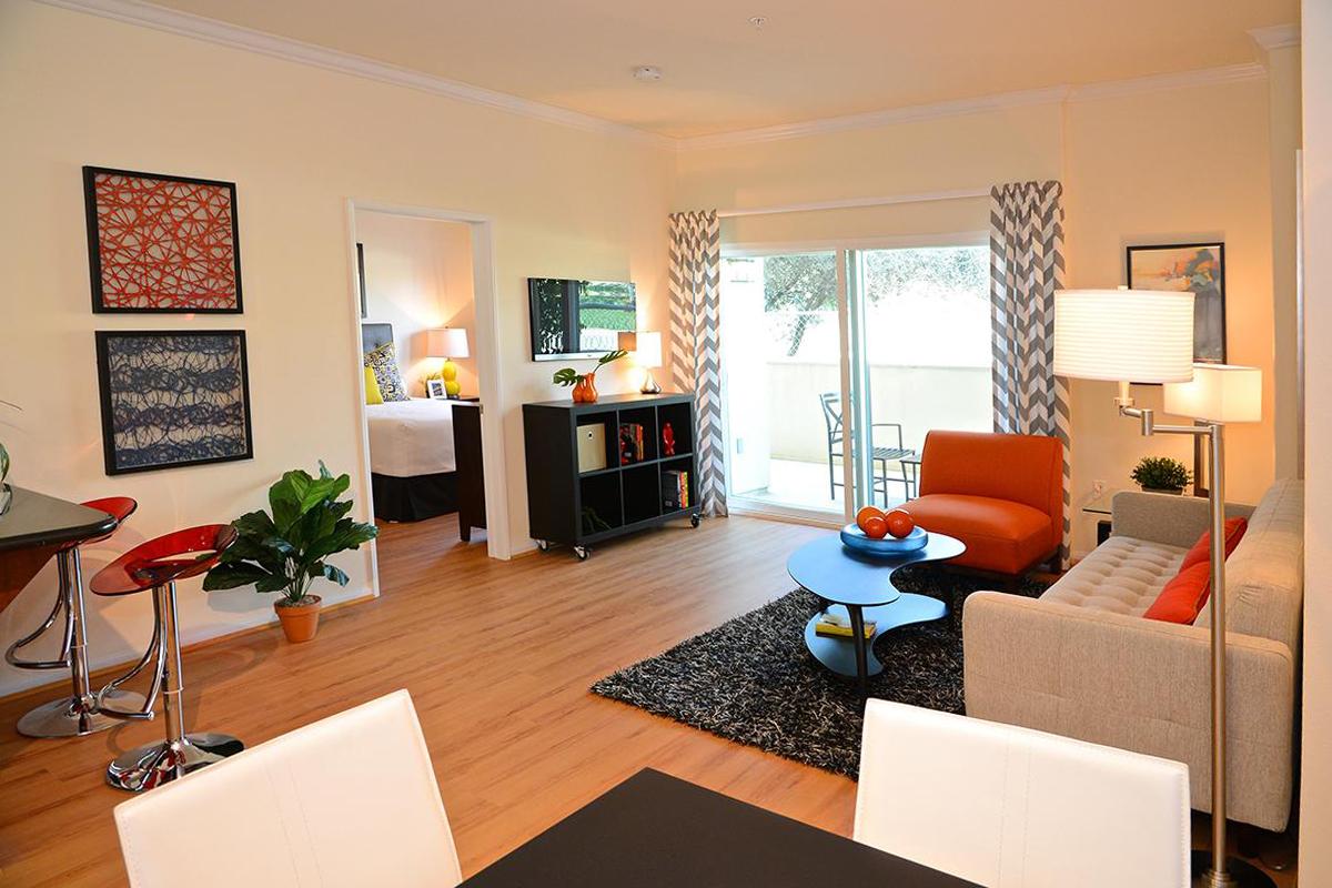 a living room filled with furniture and a flat screen tv