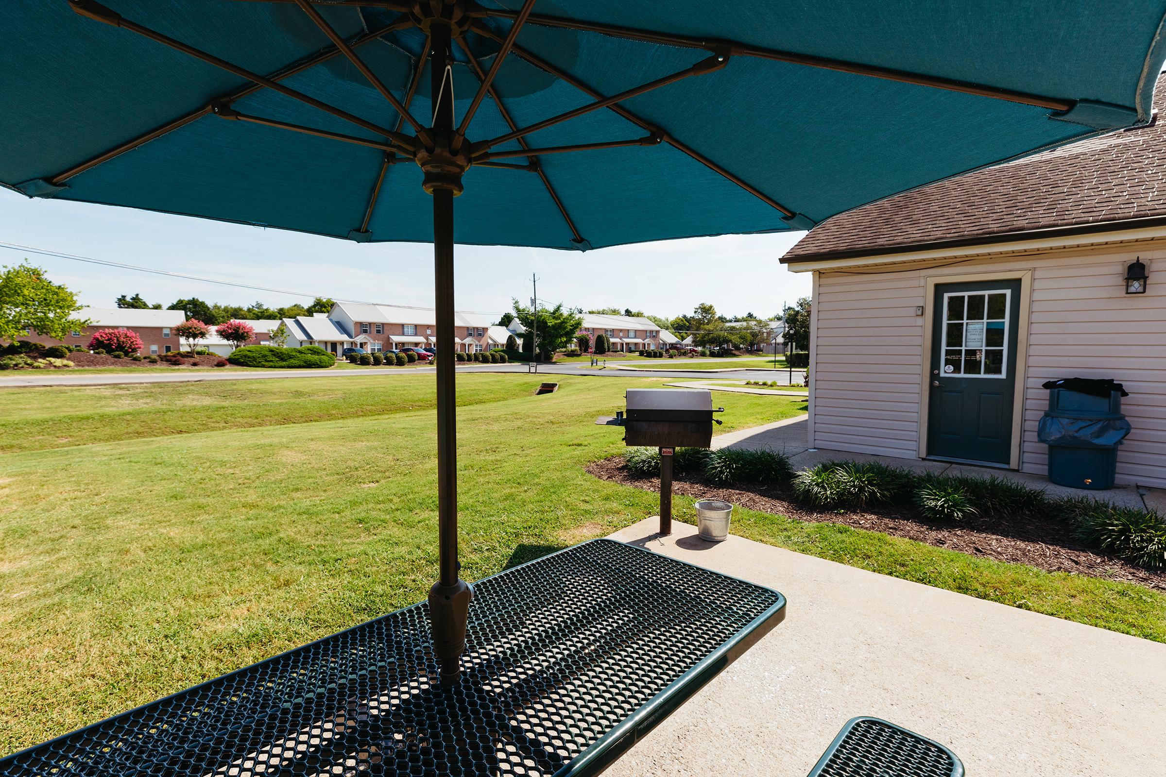 Patio umbrella and bench.