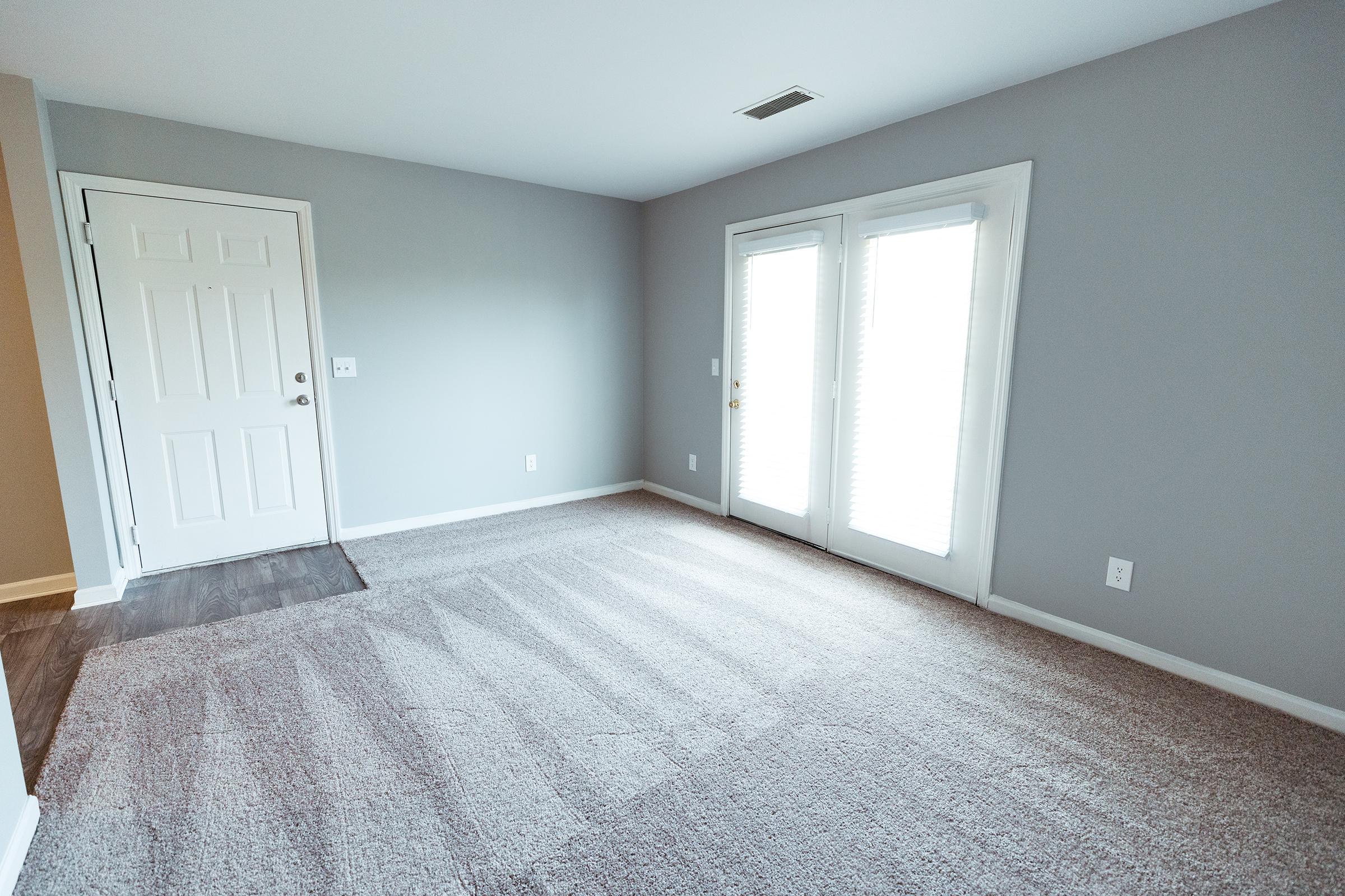 Another view of living room towards front door.