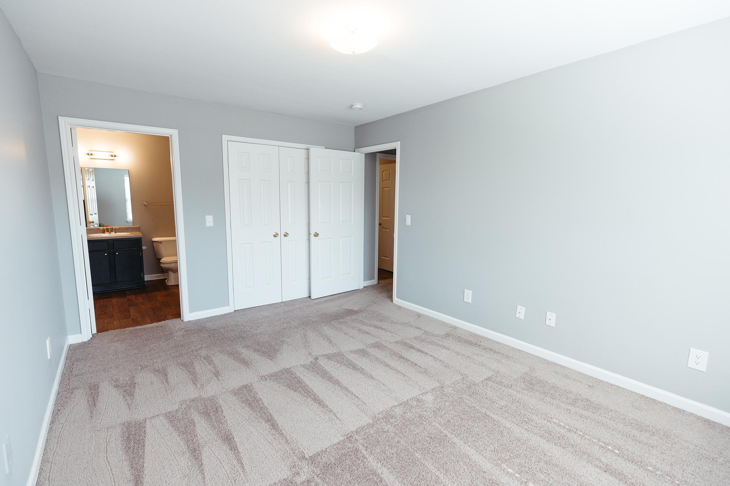 Bedroom facing entry door and bathroom.