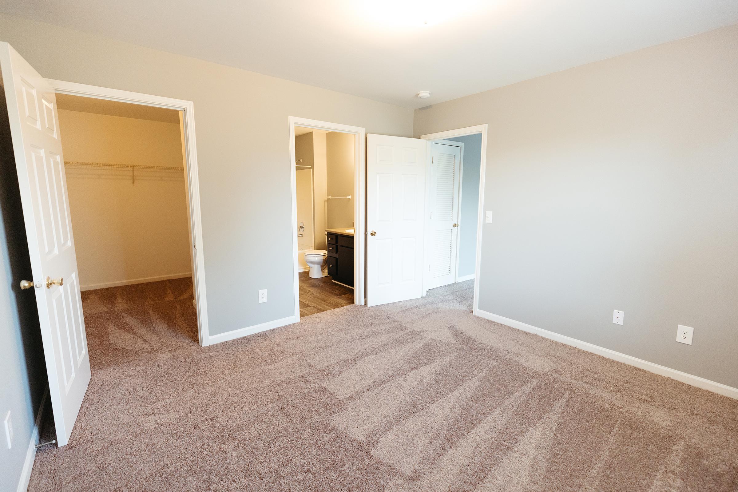 Bedroom with closet and bathroom views.