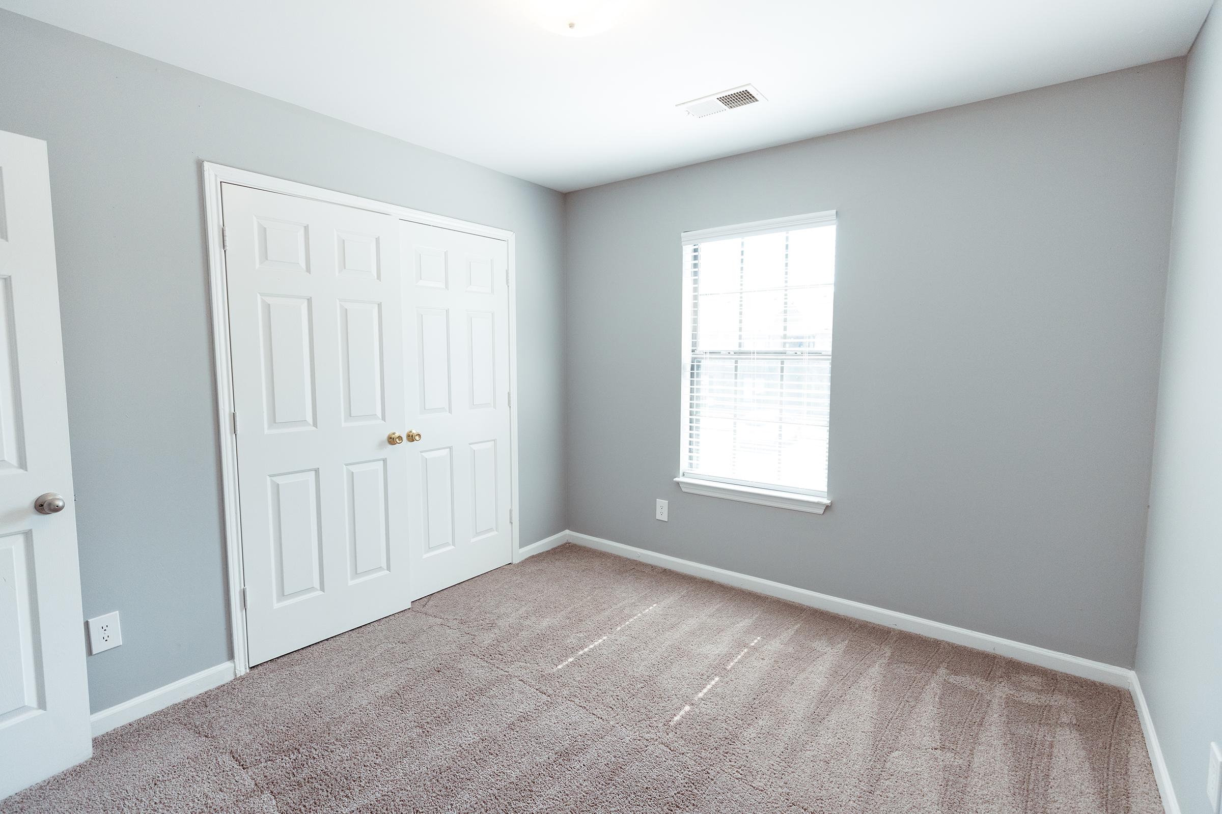 Bedroom with closet doors closed.