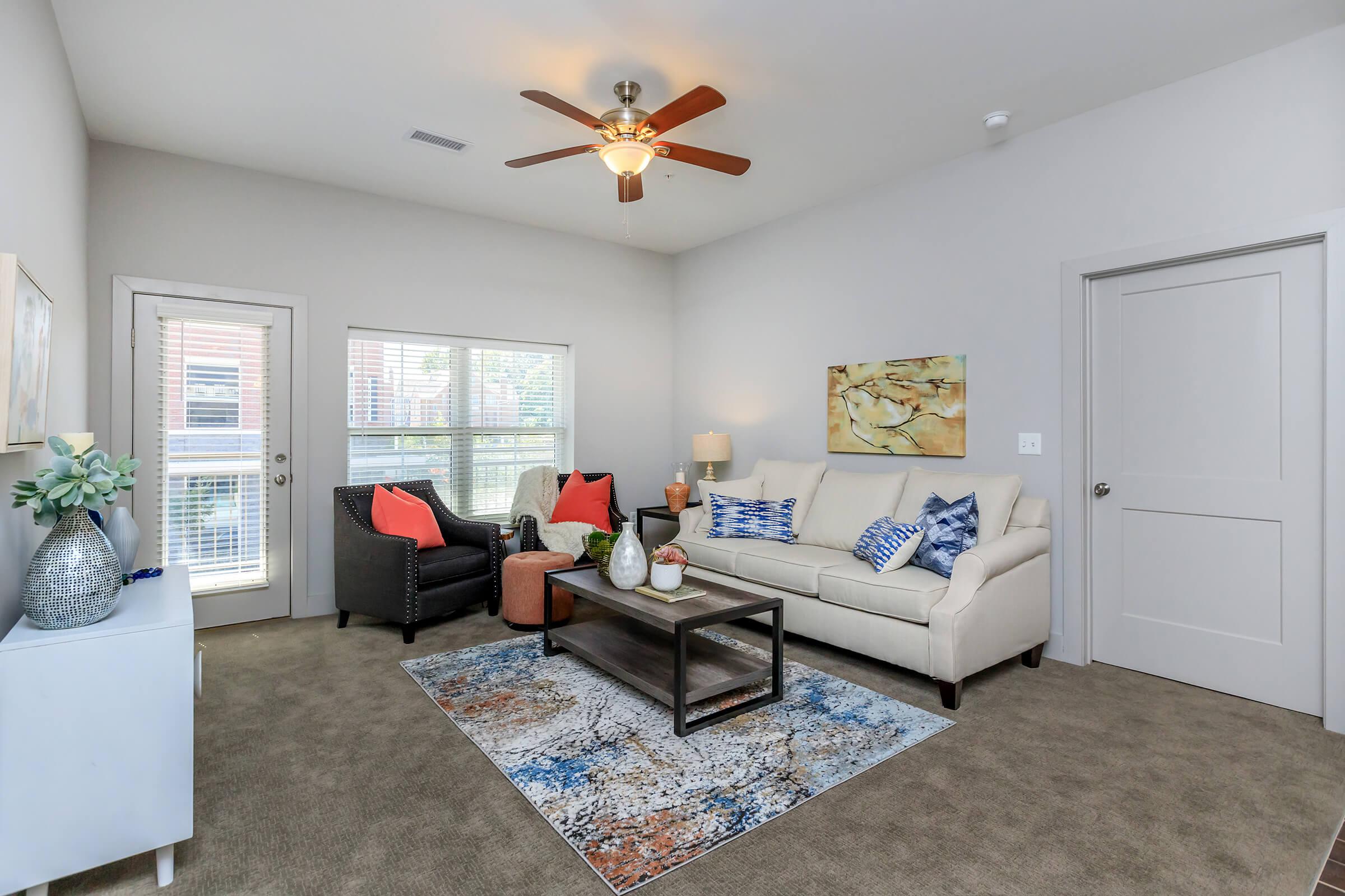 a living room filled with furniture and a flat screen tv