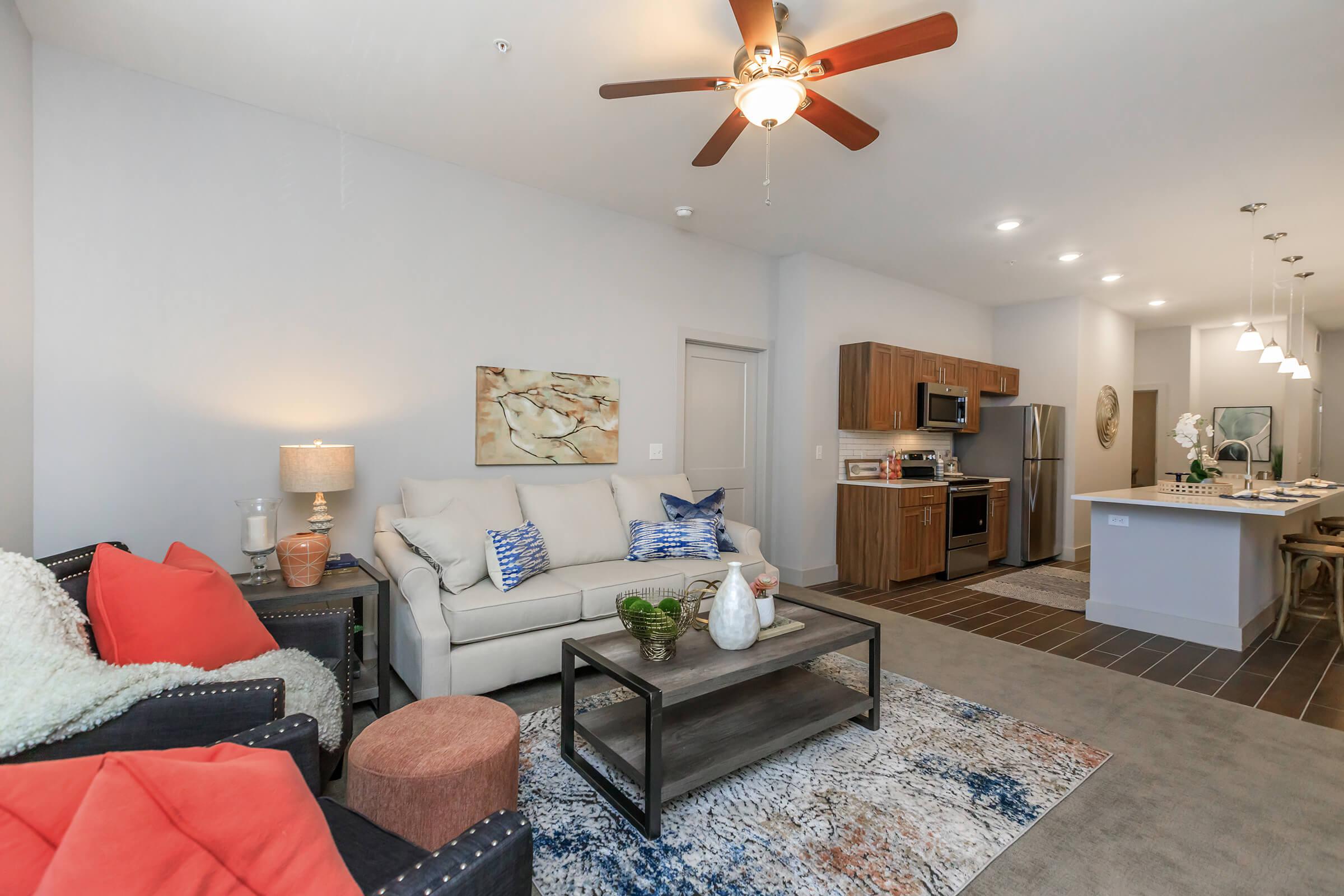 a living room filled with furniture and a bed