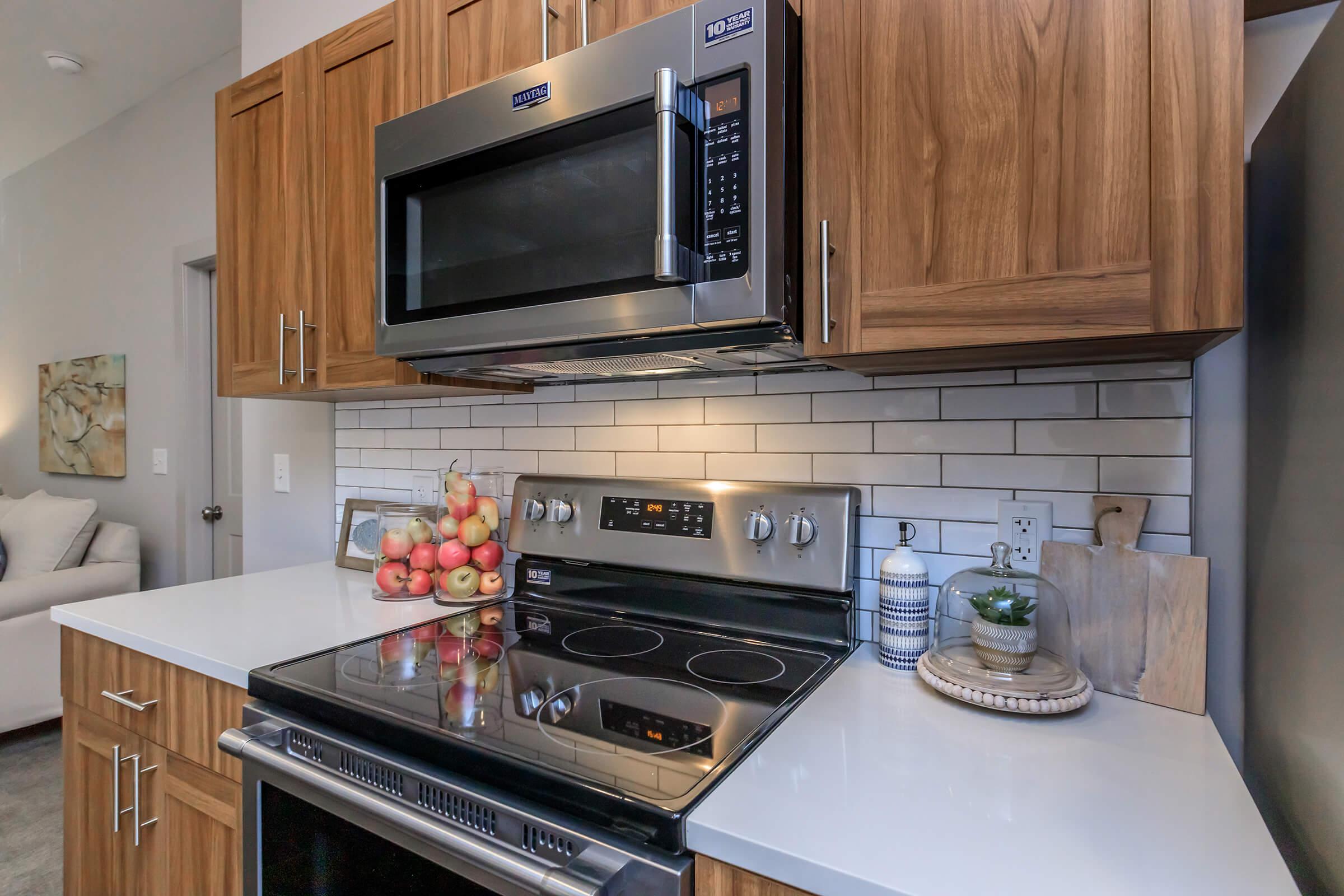 a stove top oven sitting inside of a kitchen