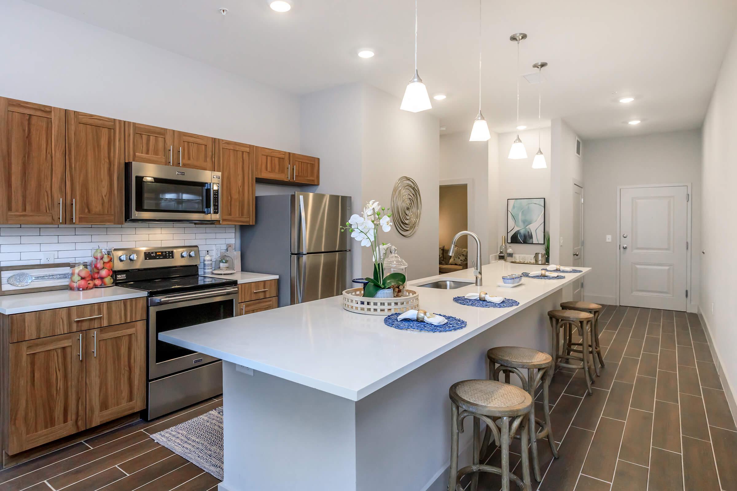 a kitchen with a sink and a dining table