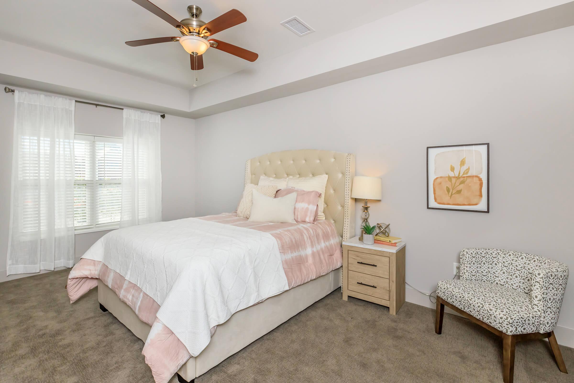 a bedroom with a bed and desk in a room