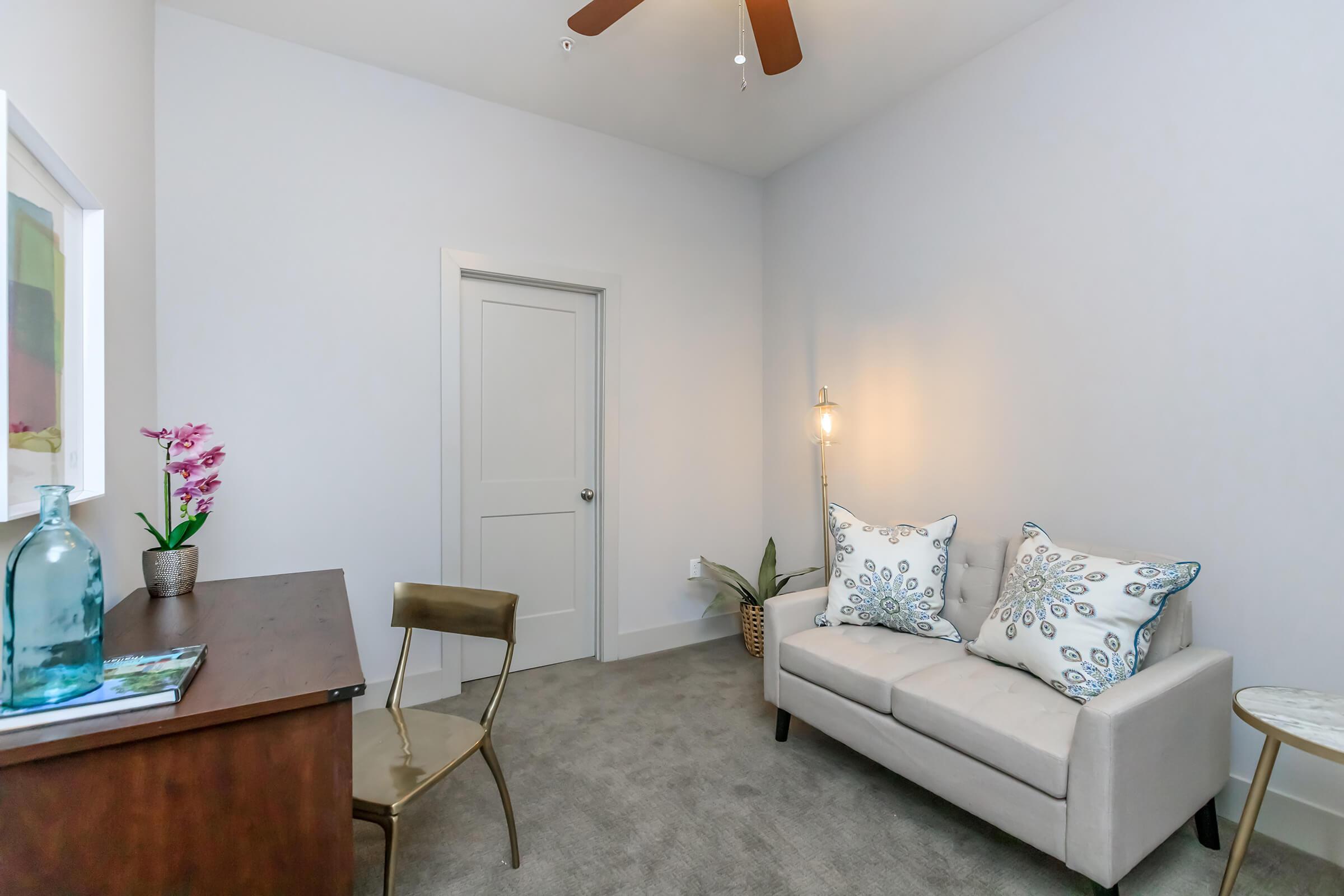 a living room filled with furniture and a lamp