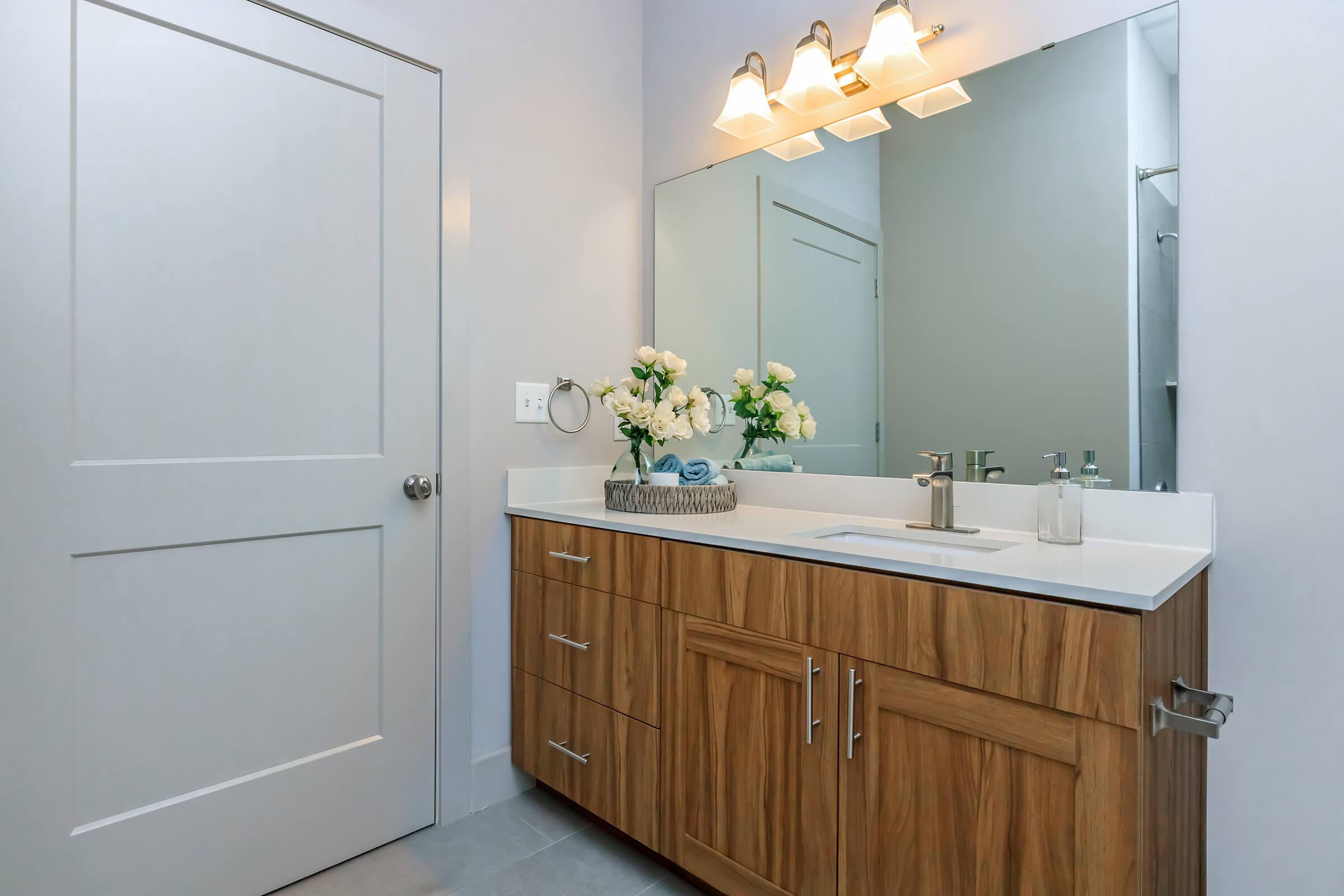 a kitchen with a sink and a mirror