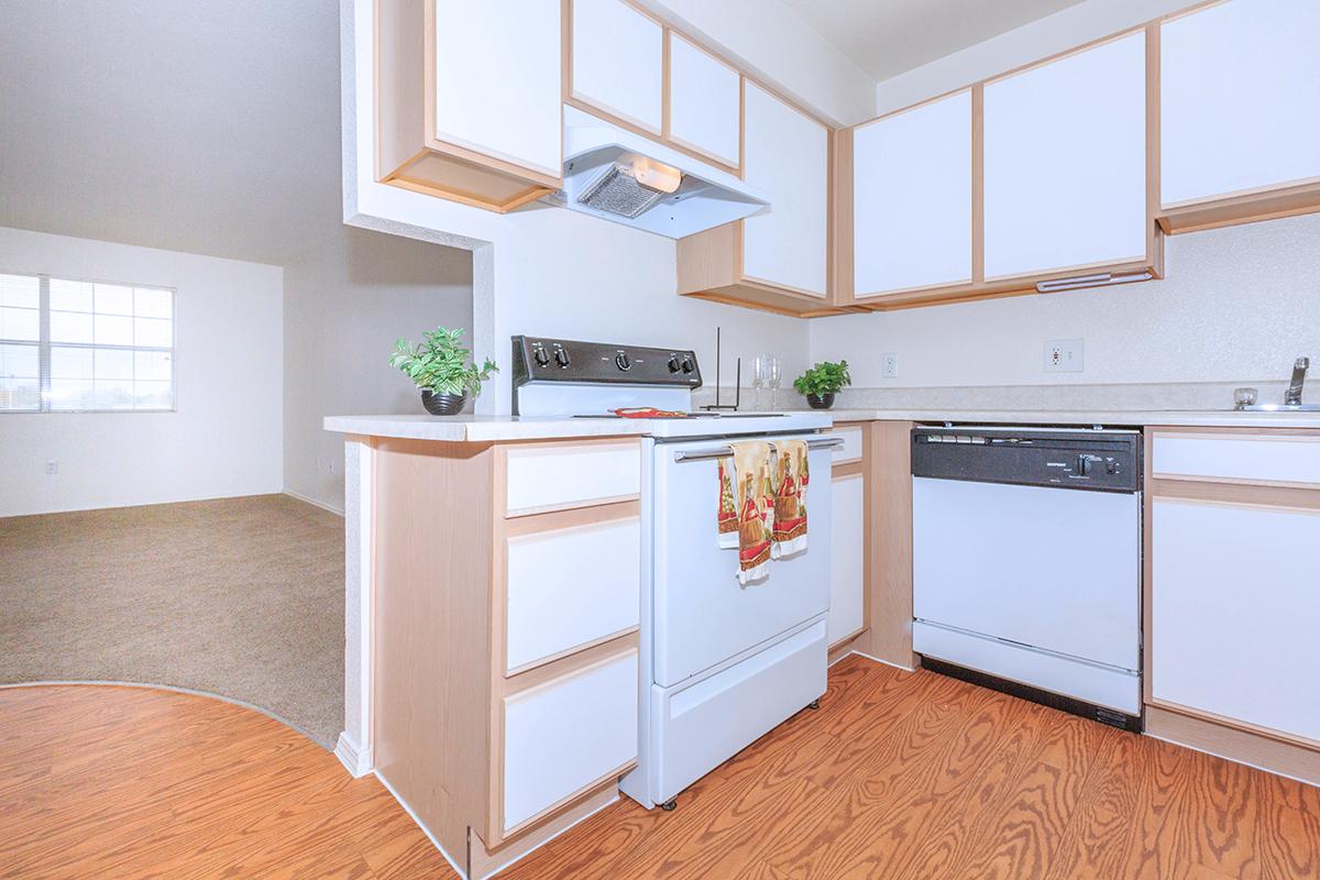 a kitchen with a stove top oven sitting inside of a room