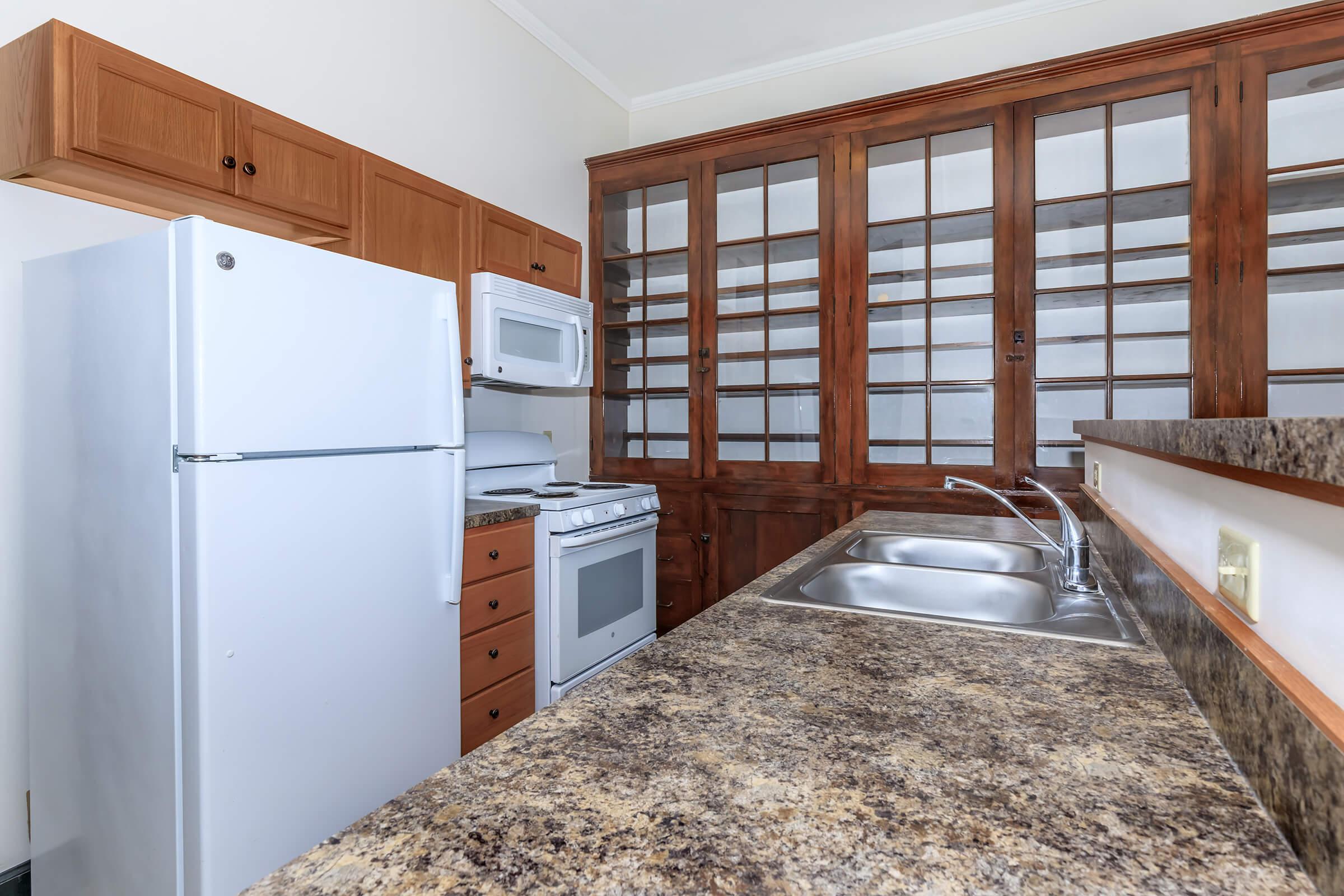 a bedroom with a bed and window in a kitchen