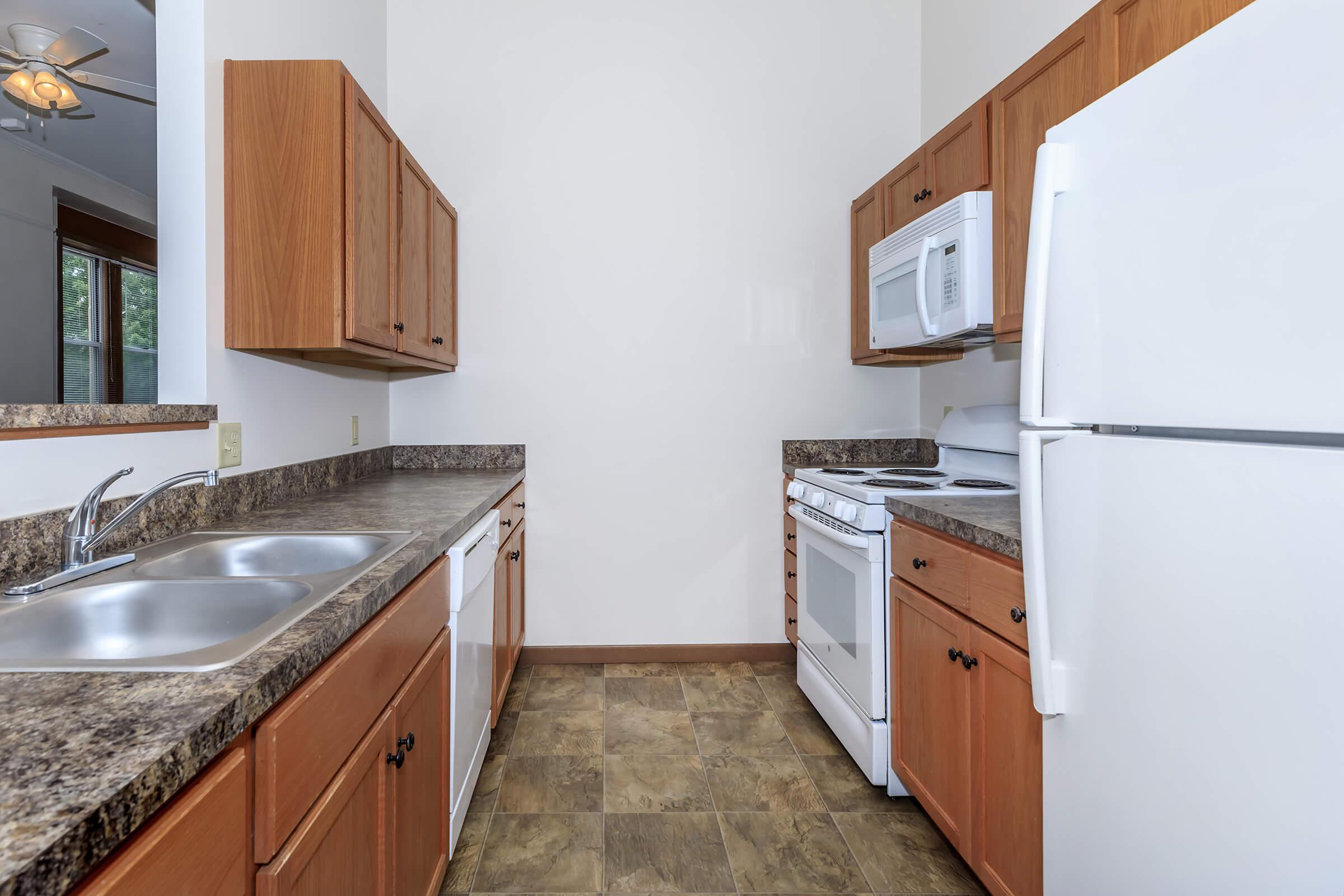 a kitchen with a stove sink and refrigerator