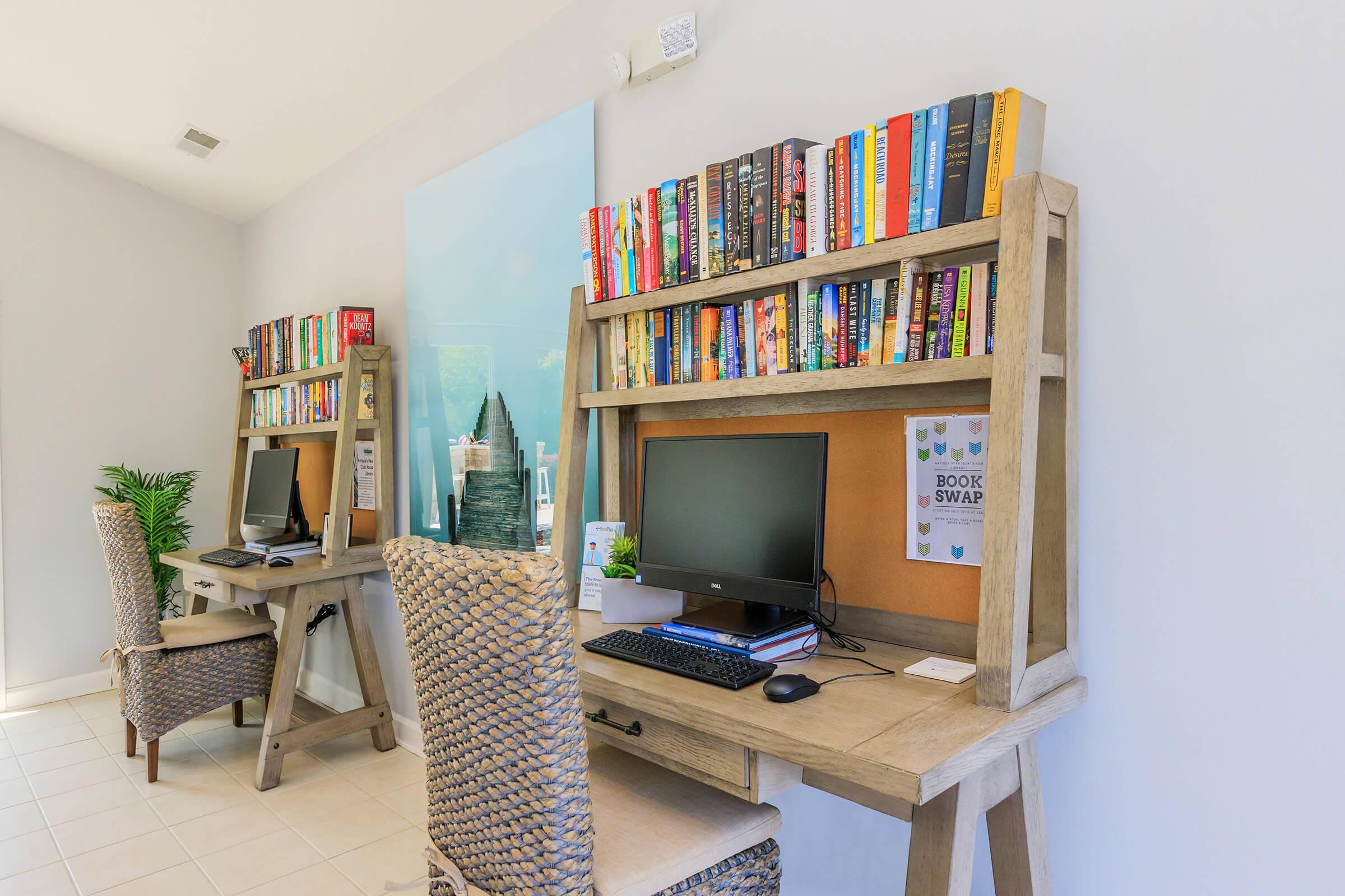 a living room filled with furniture and a book shelf