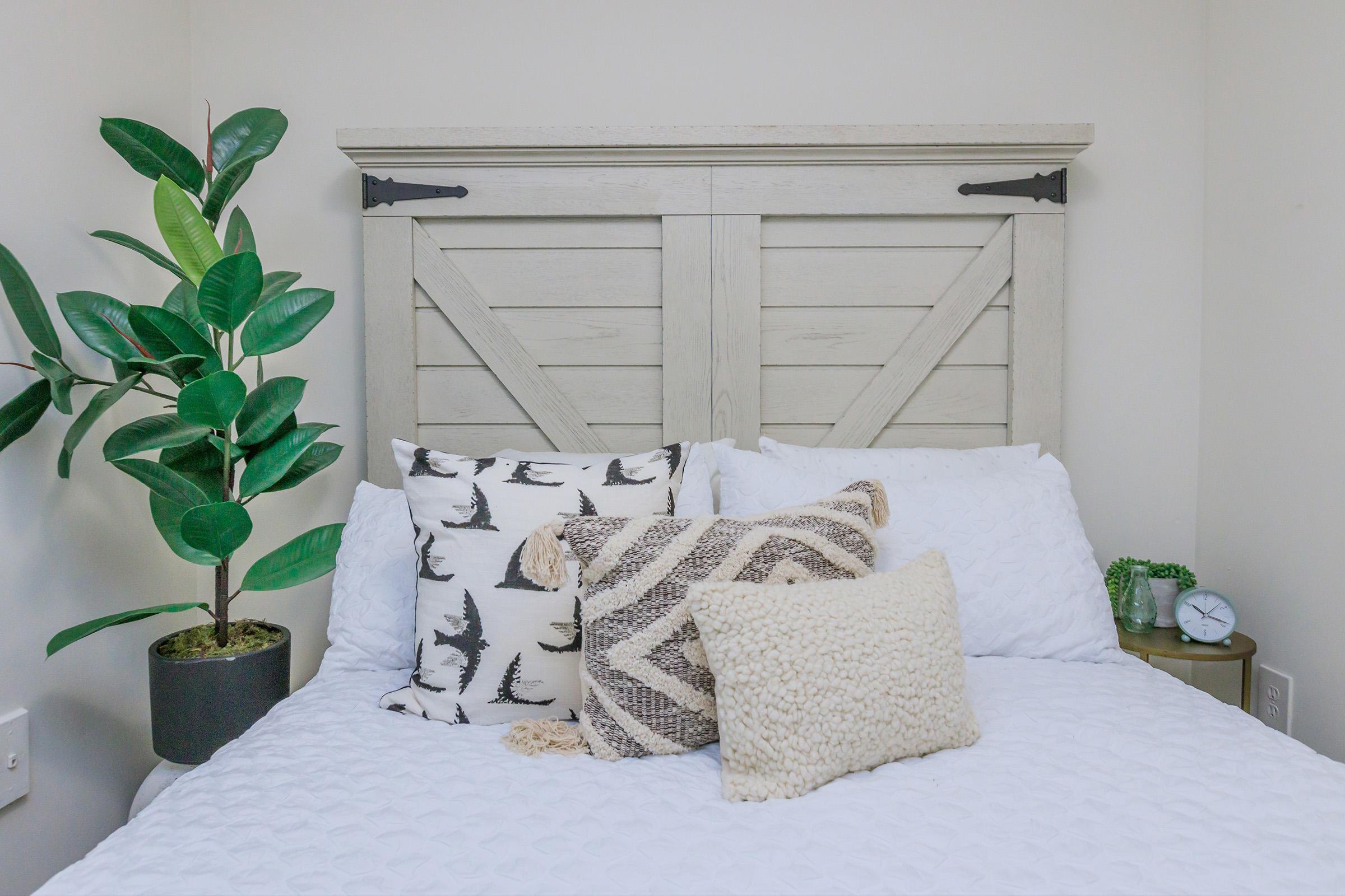 a vase of flowers sitting on a bed