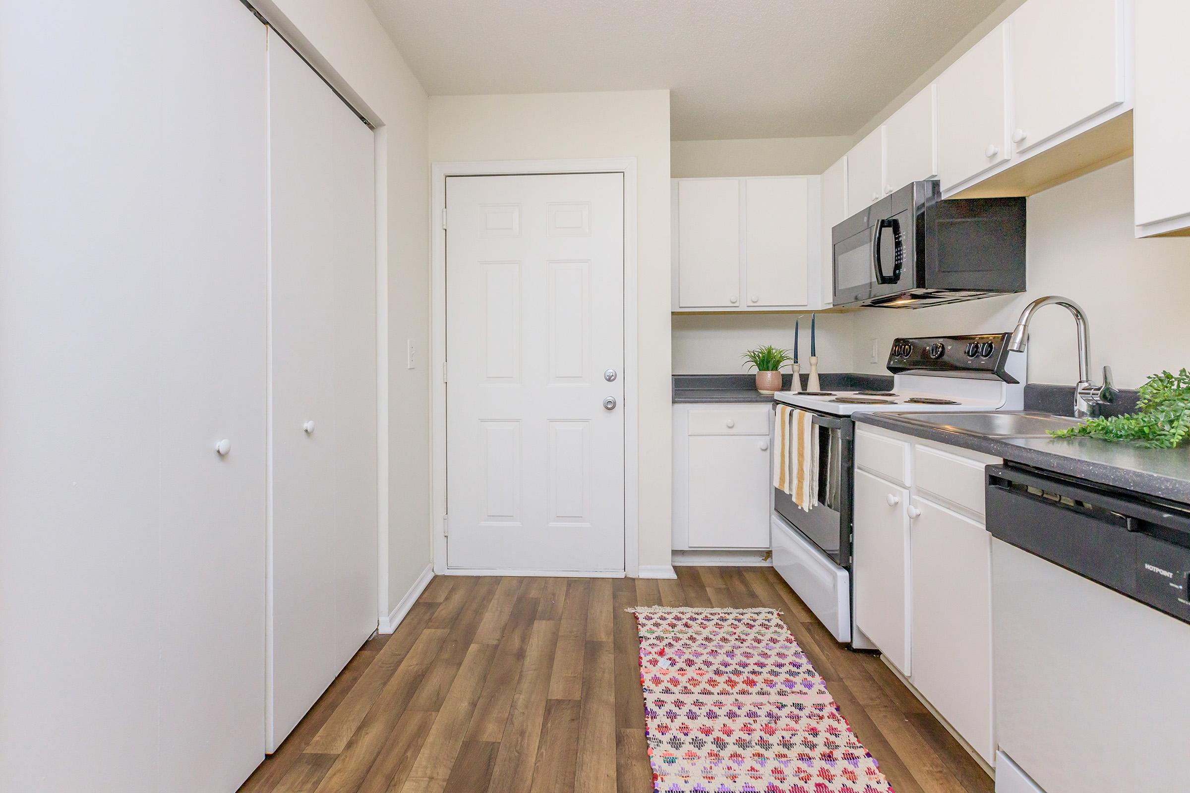 a kitchen with a stove and a refrigerator