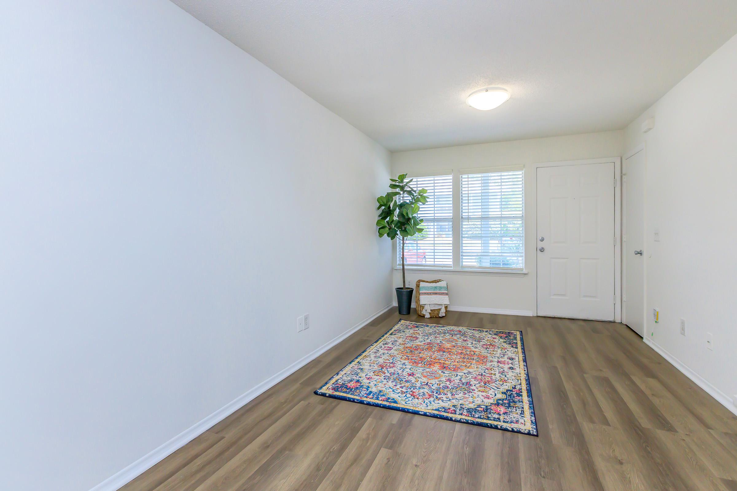 a bedroom with a wooden floor