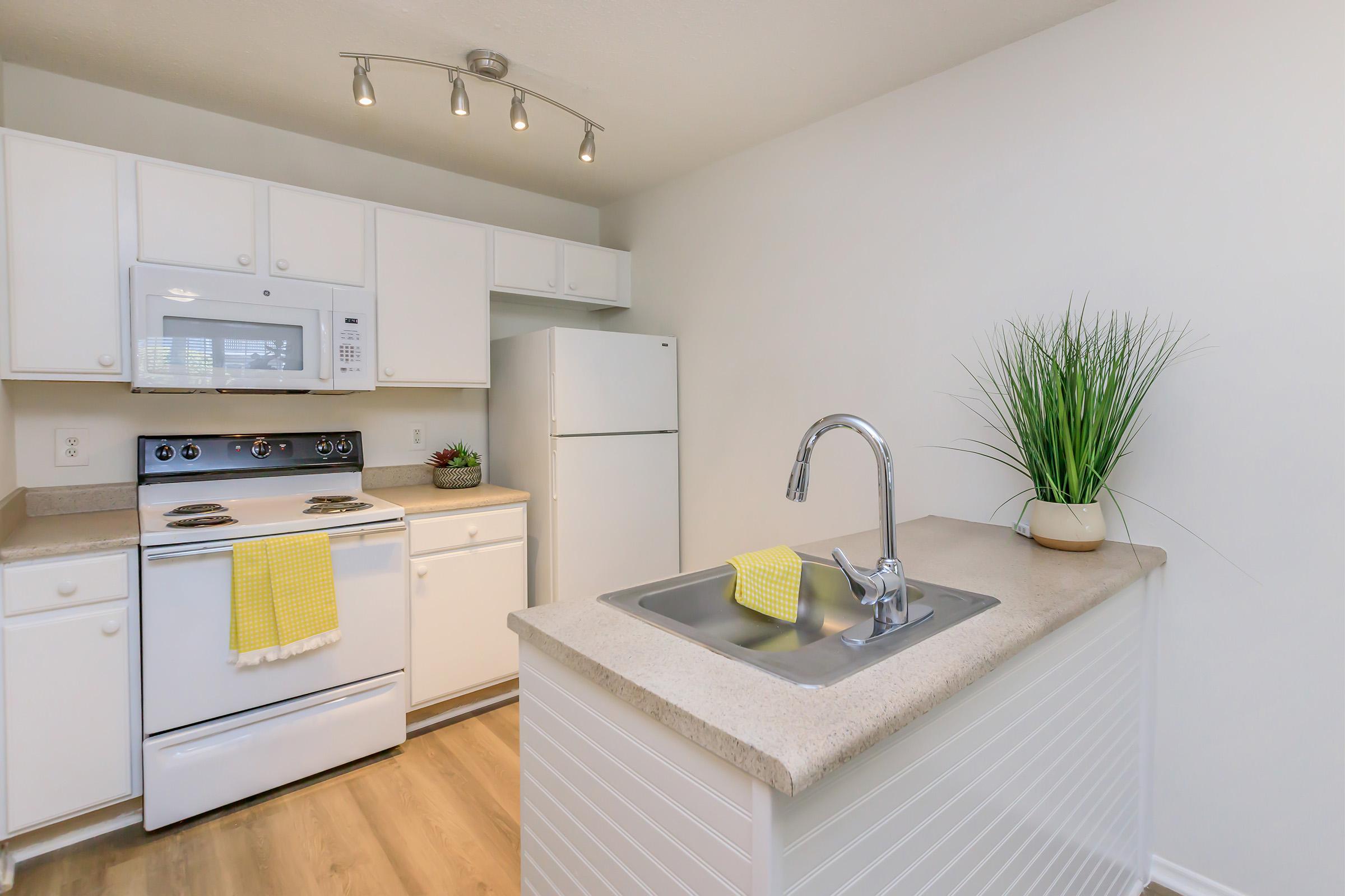 a kitchen with a sink and a refrigerator