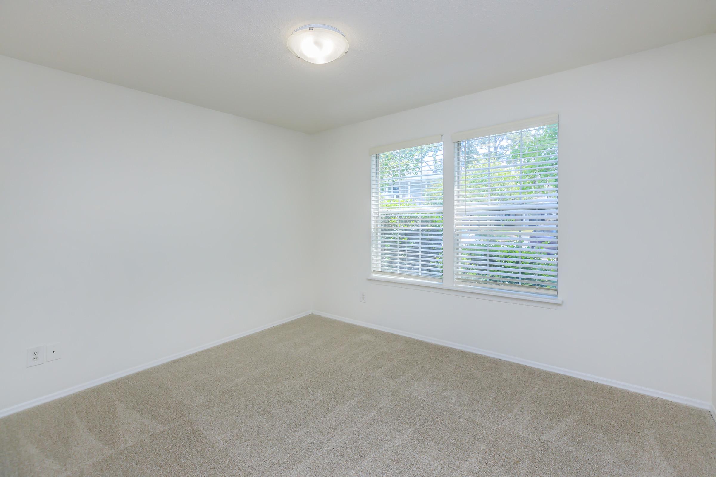 a bedroom with a large window