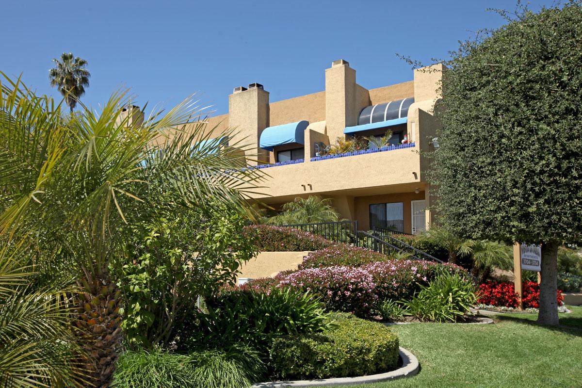 a house with bushes in front of a building