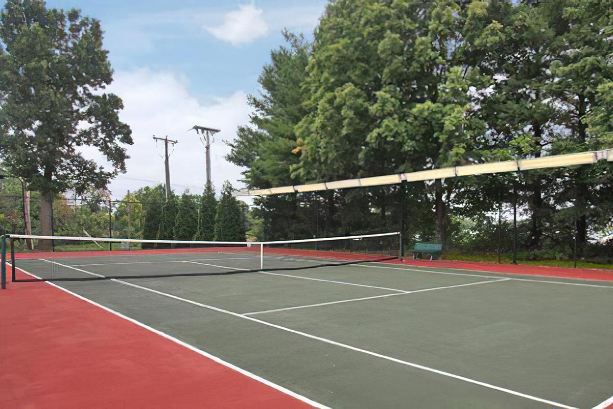 a basketball on a court with a racket