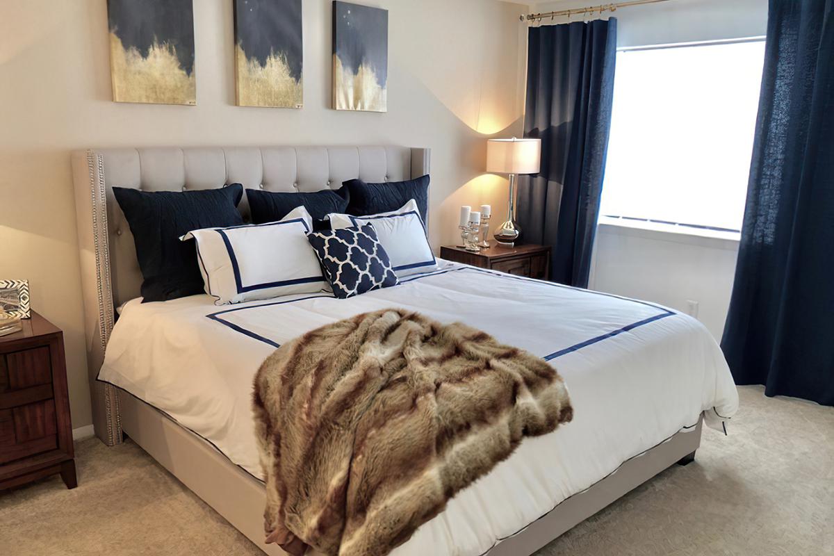 a bedroom with a bed and desk in a room