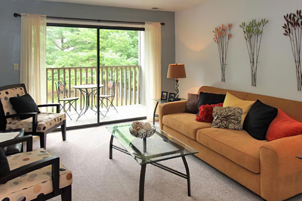 a living room filled with furniture and a large window
