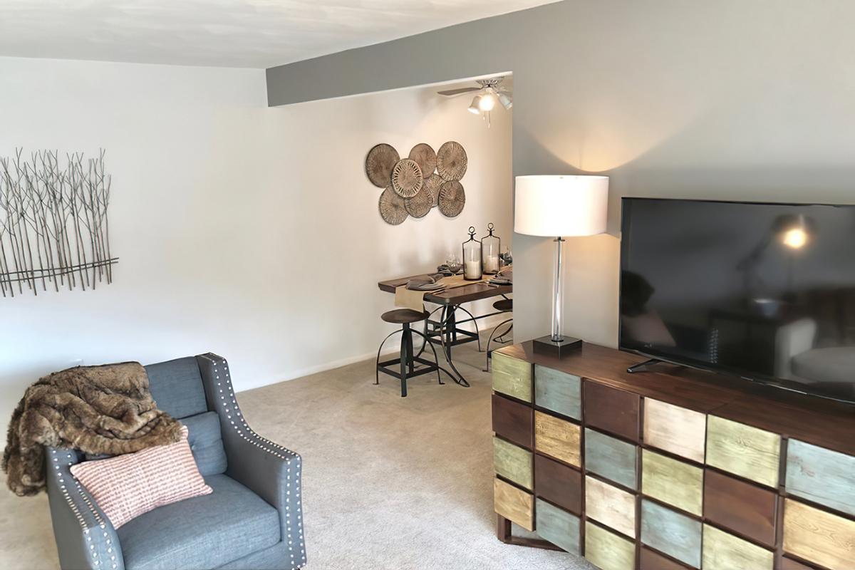 a living room filled with furniture and a flat screen tv